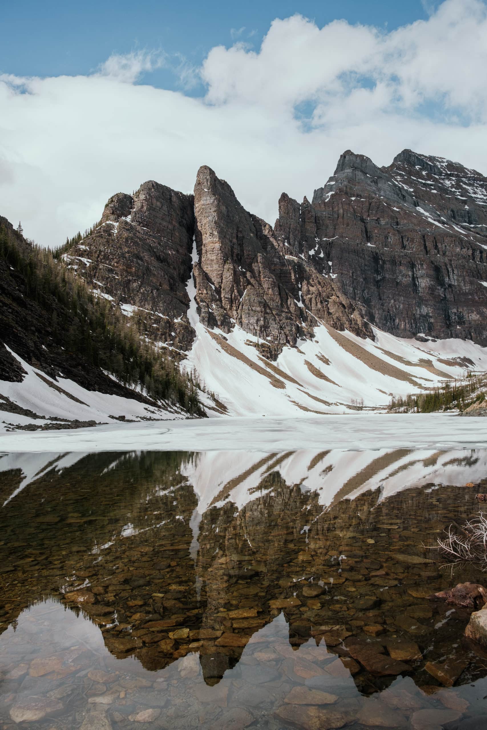 Mountains reflecting in Lake Agnes.