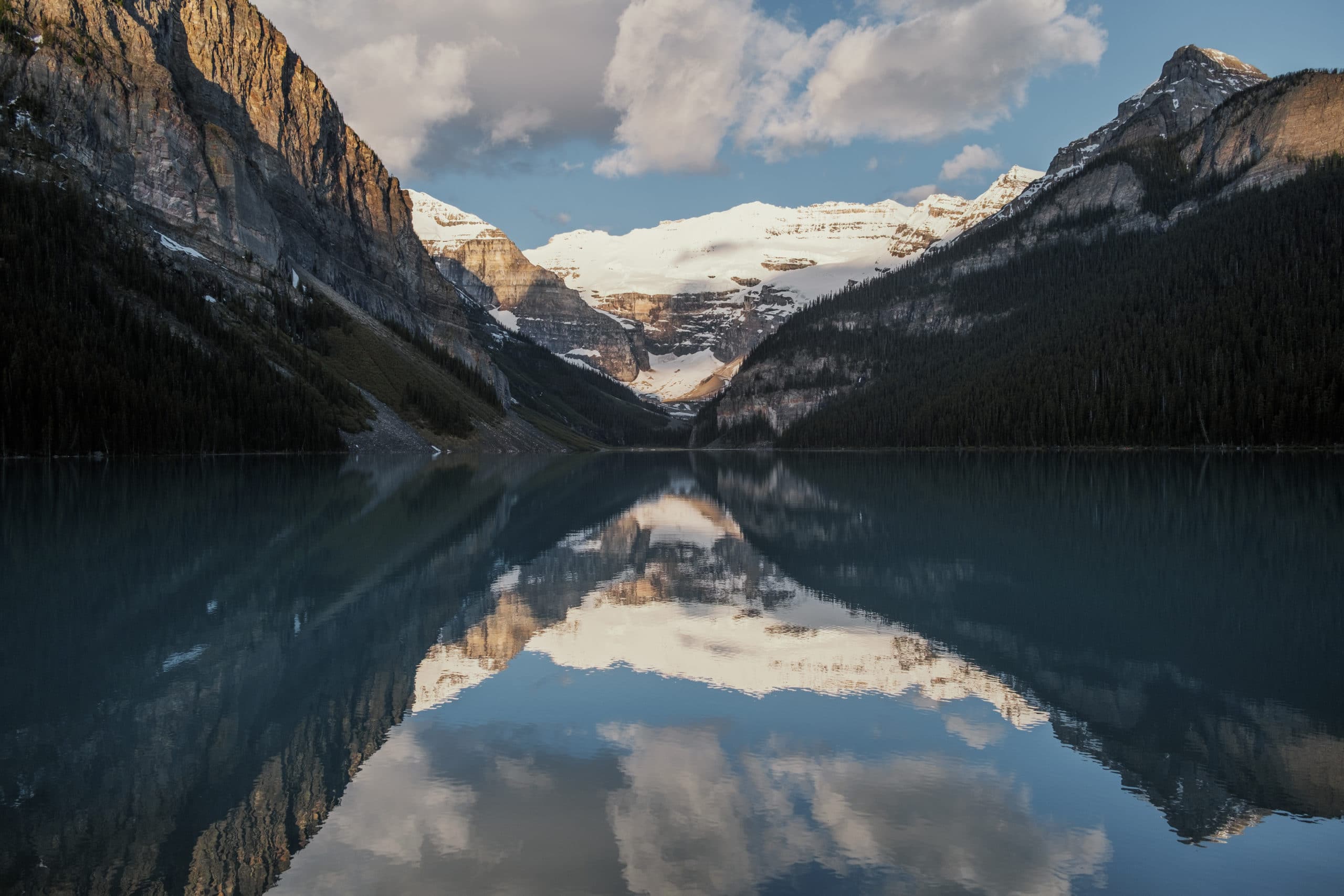 Mountains reflect in Lake Louise.