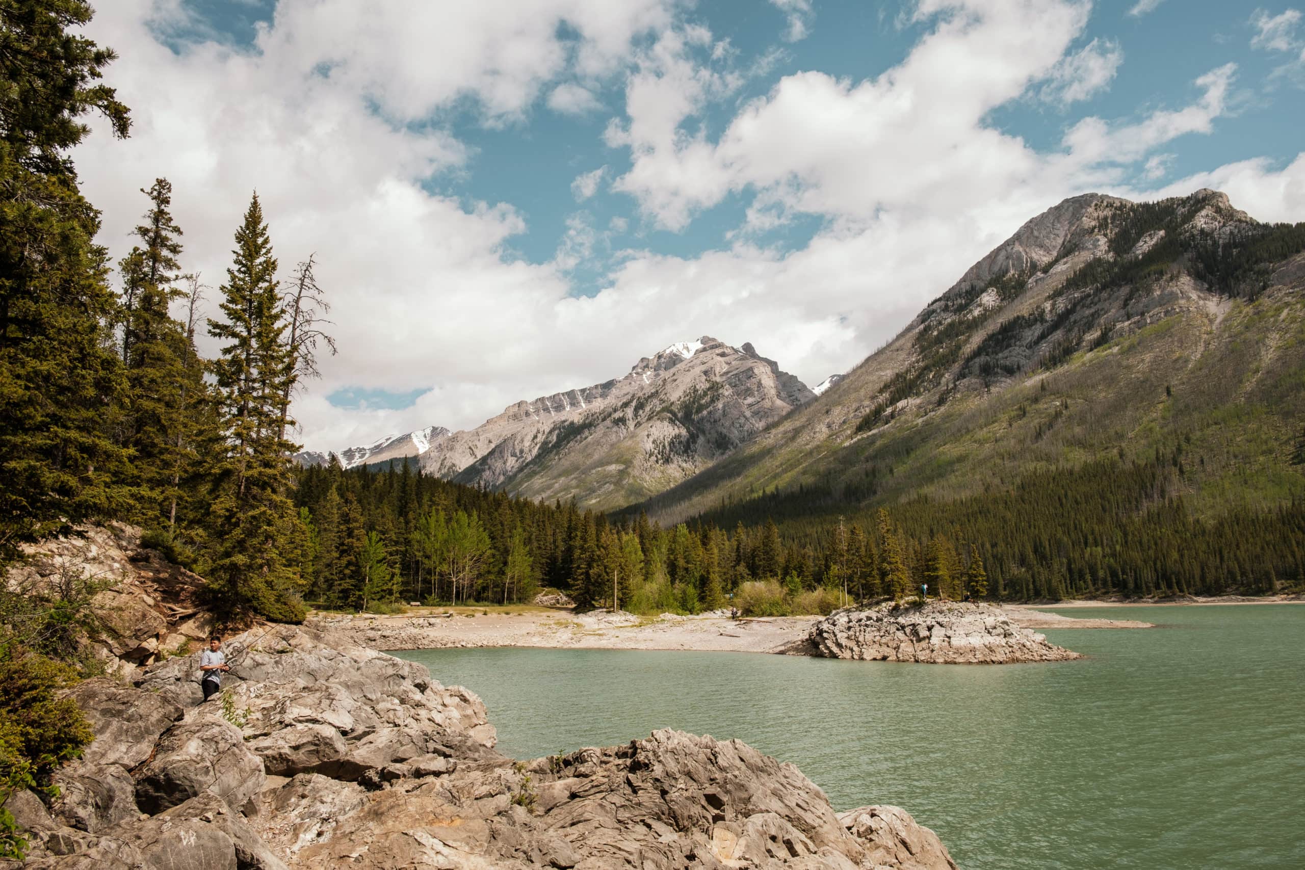 Mountains and trees beside Lake Minnewanka.
