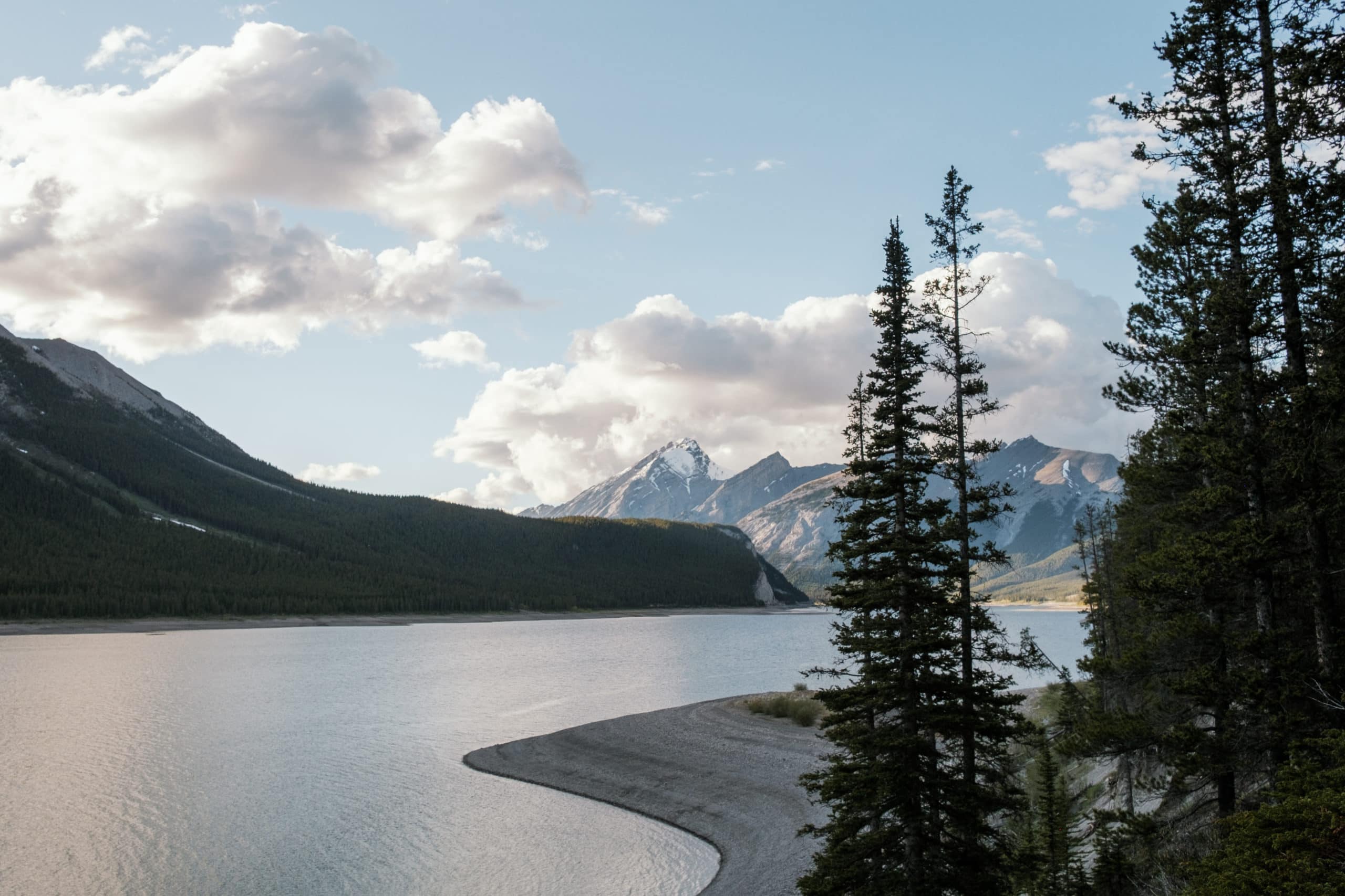 A lake between several snow-covered mountains.