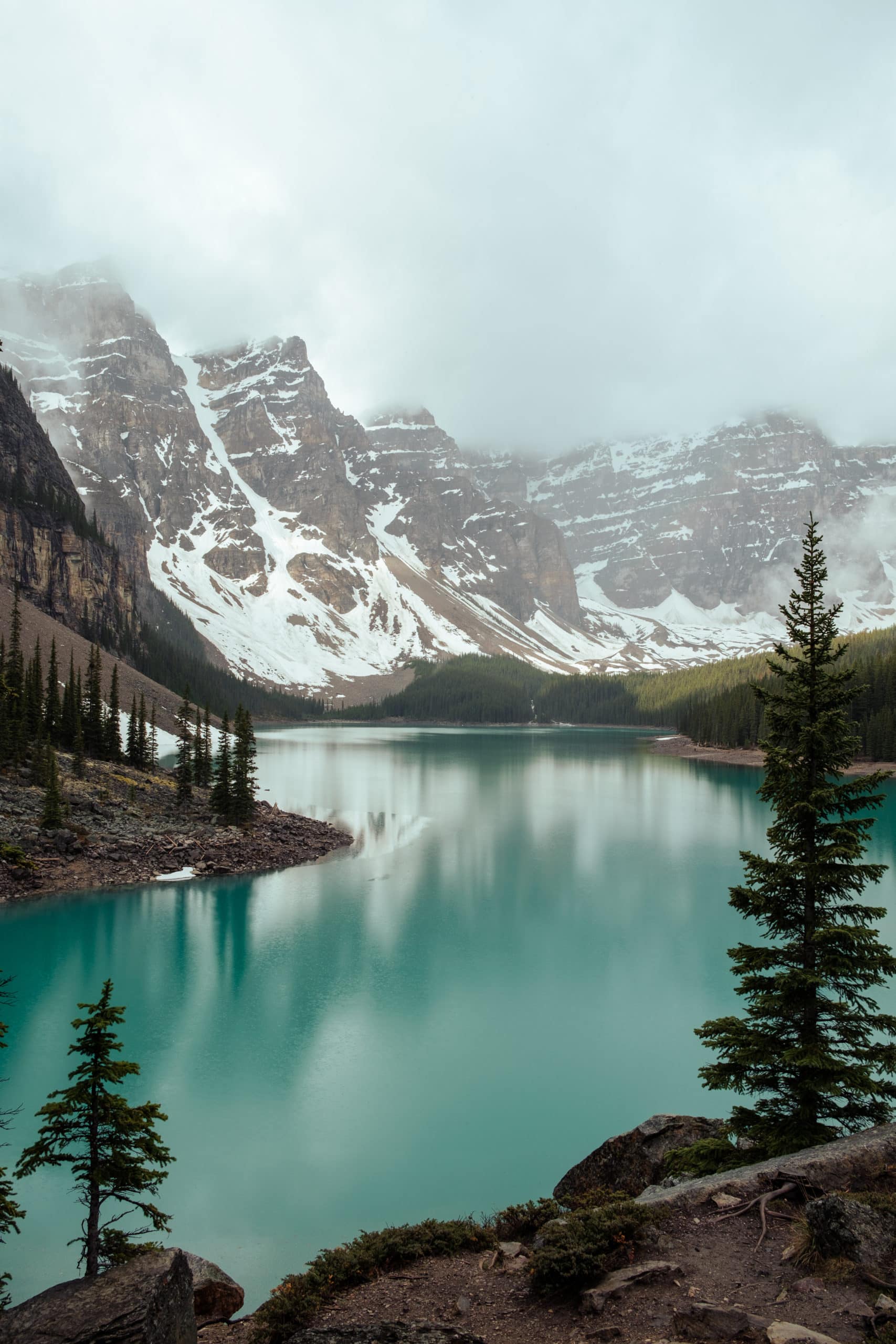 Snow-covered mountains behind the turquoise-colored Moraine Lake.