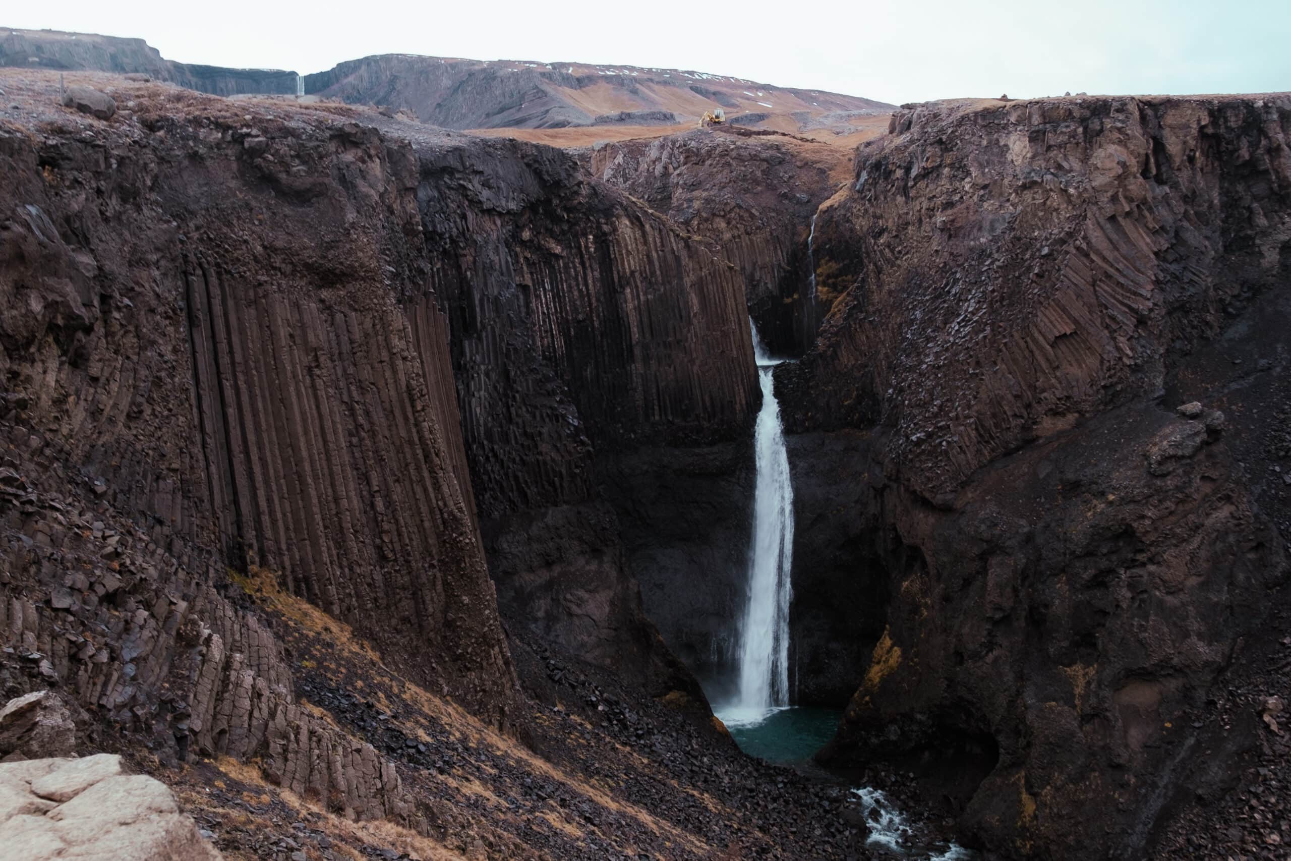 Litlanesfoss spills over columns of rocks.