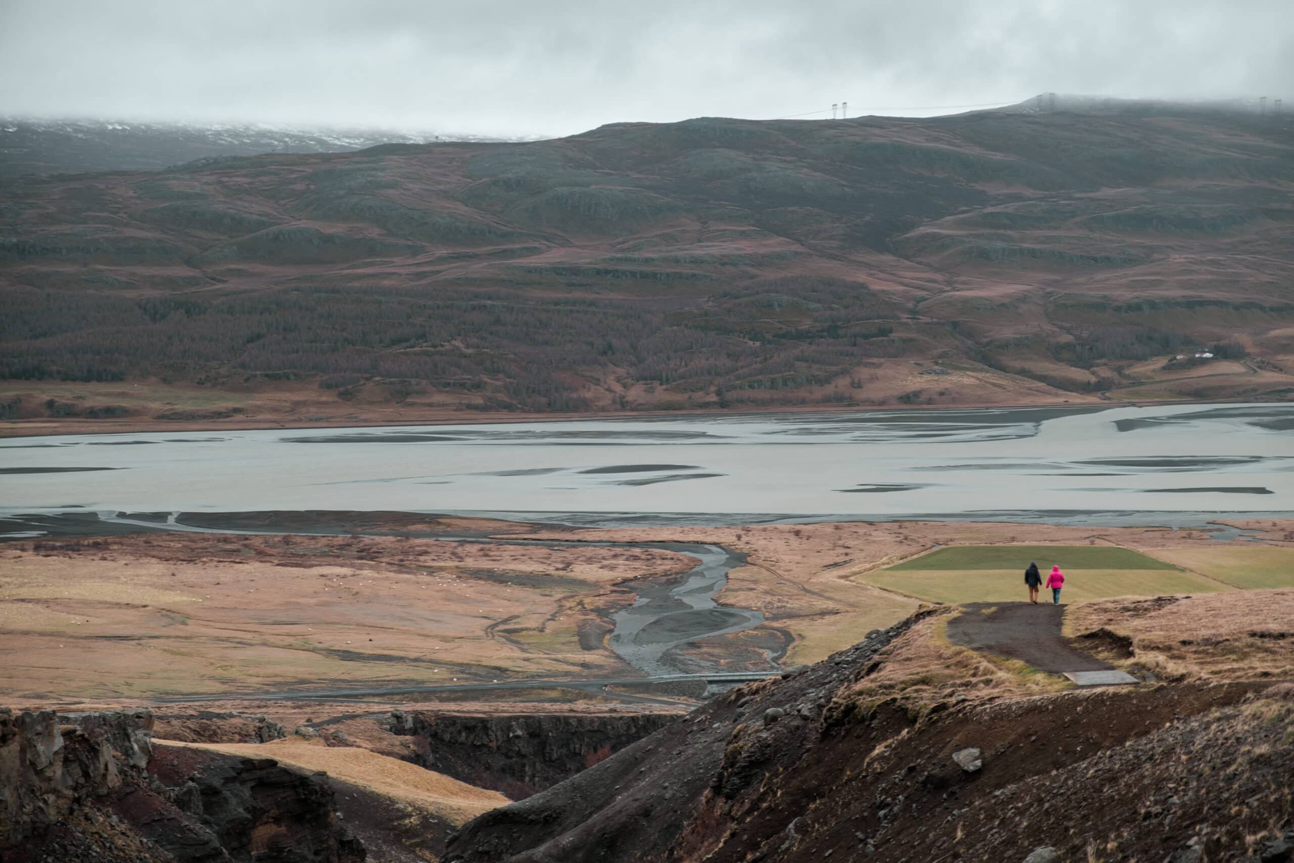 People hike down from Hengifoss.
