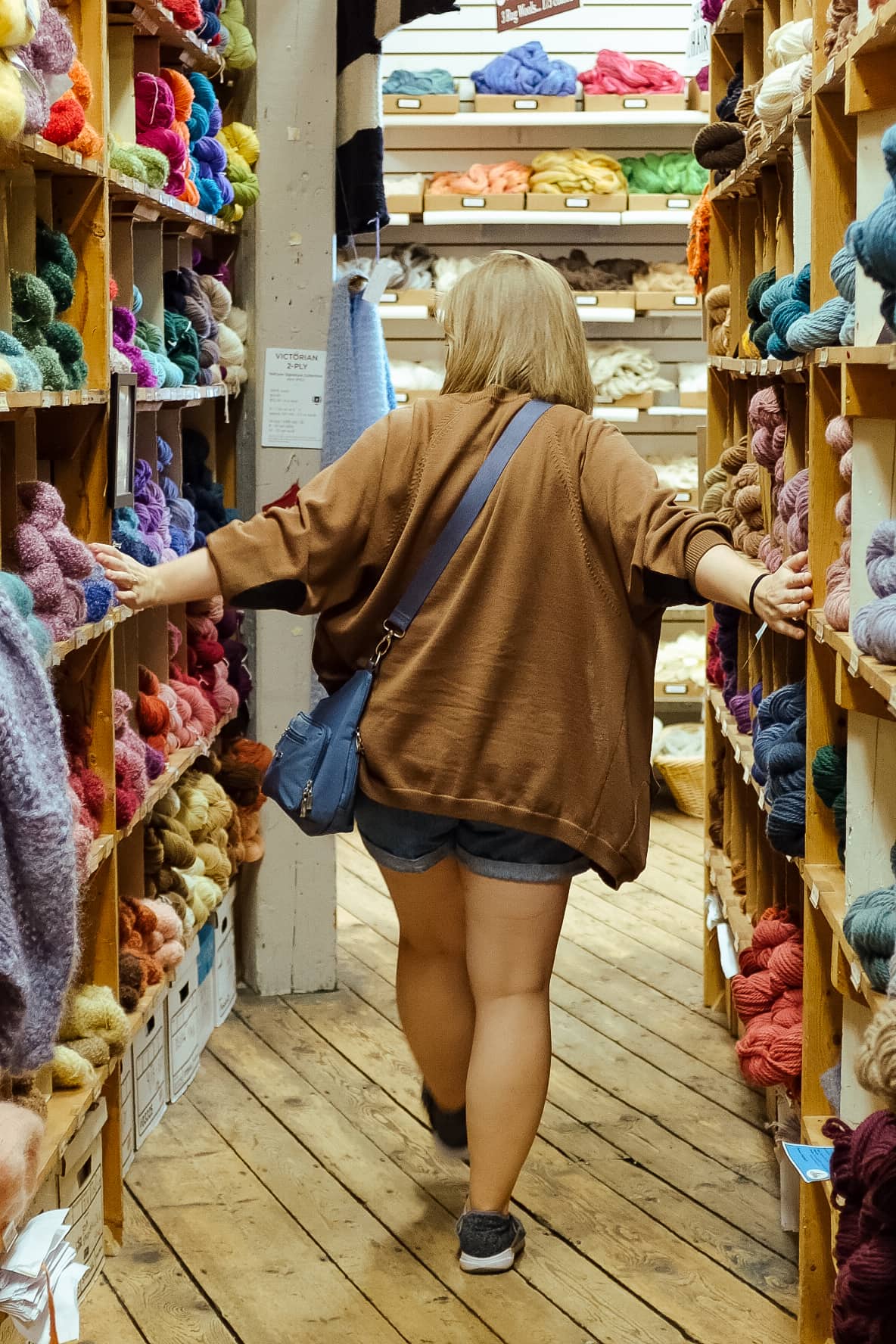 My sister walks through a yarn store.