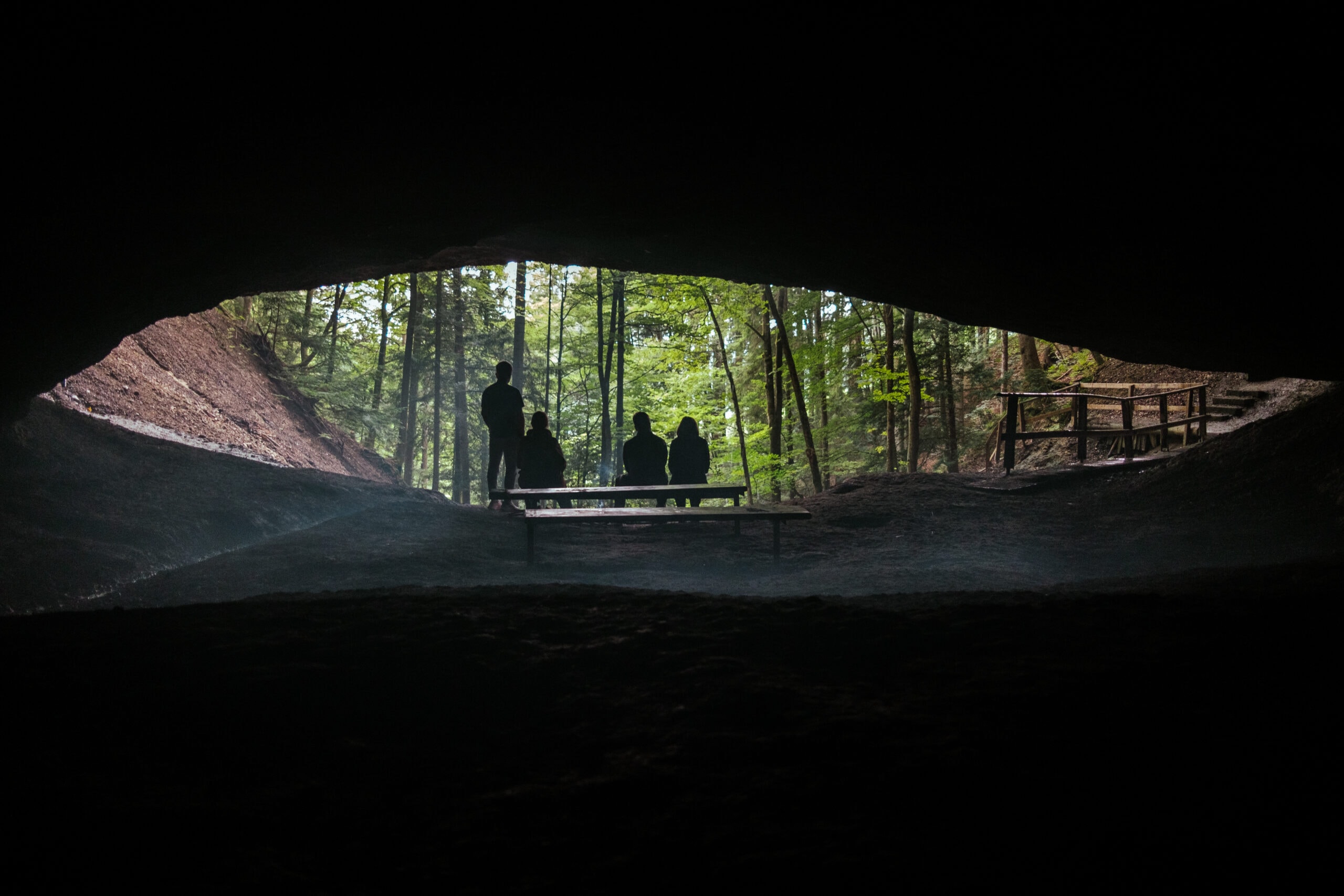 People at the narrow entrance to the Tauferhohle cave.