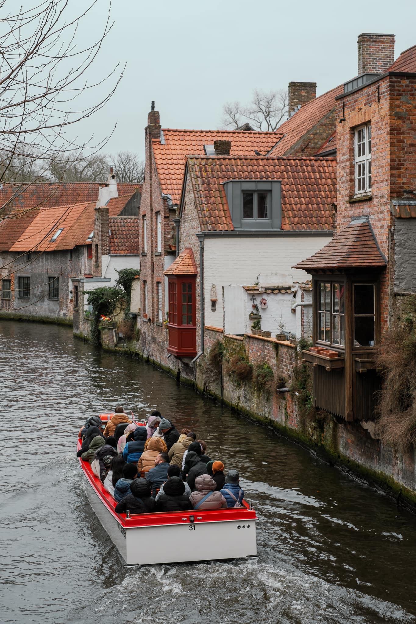 A boat going through the canals of Bruges.