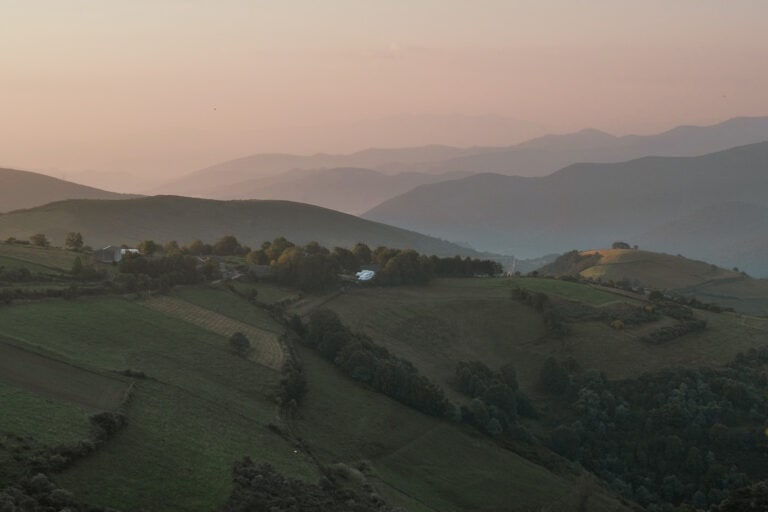 Rolling hills glow in the early morning light.