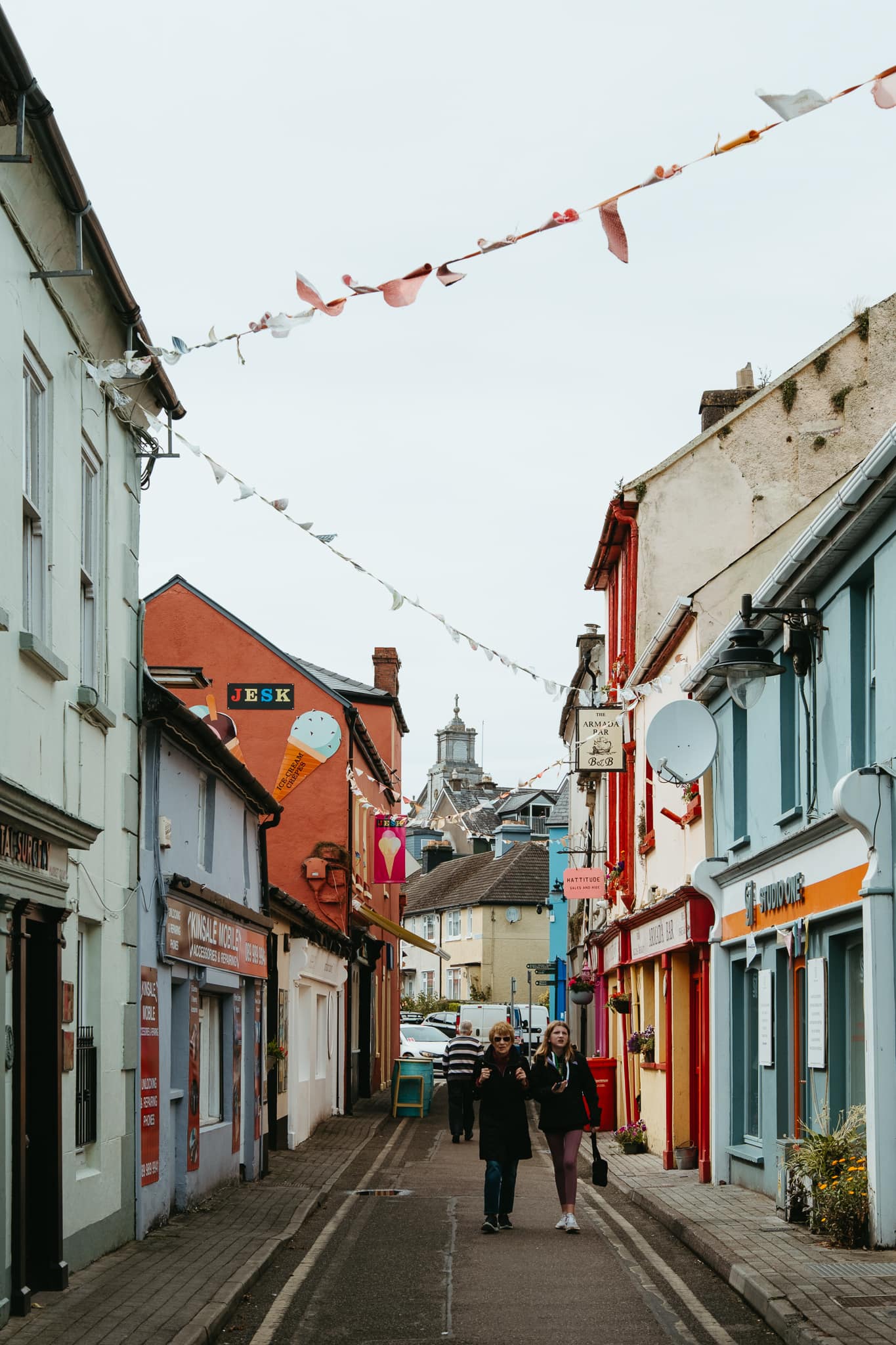 People walk through the colorful town of Kinsale, Ireland.
