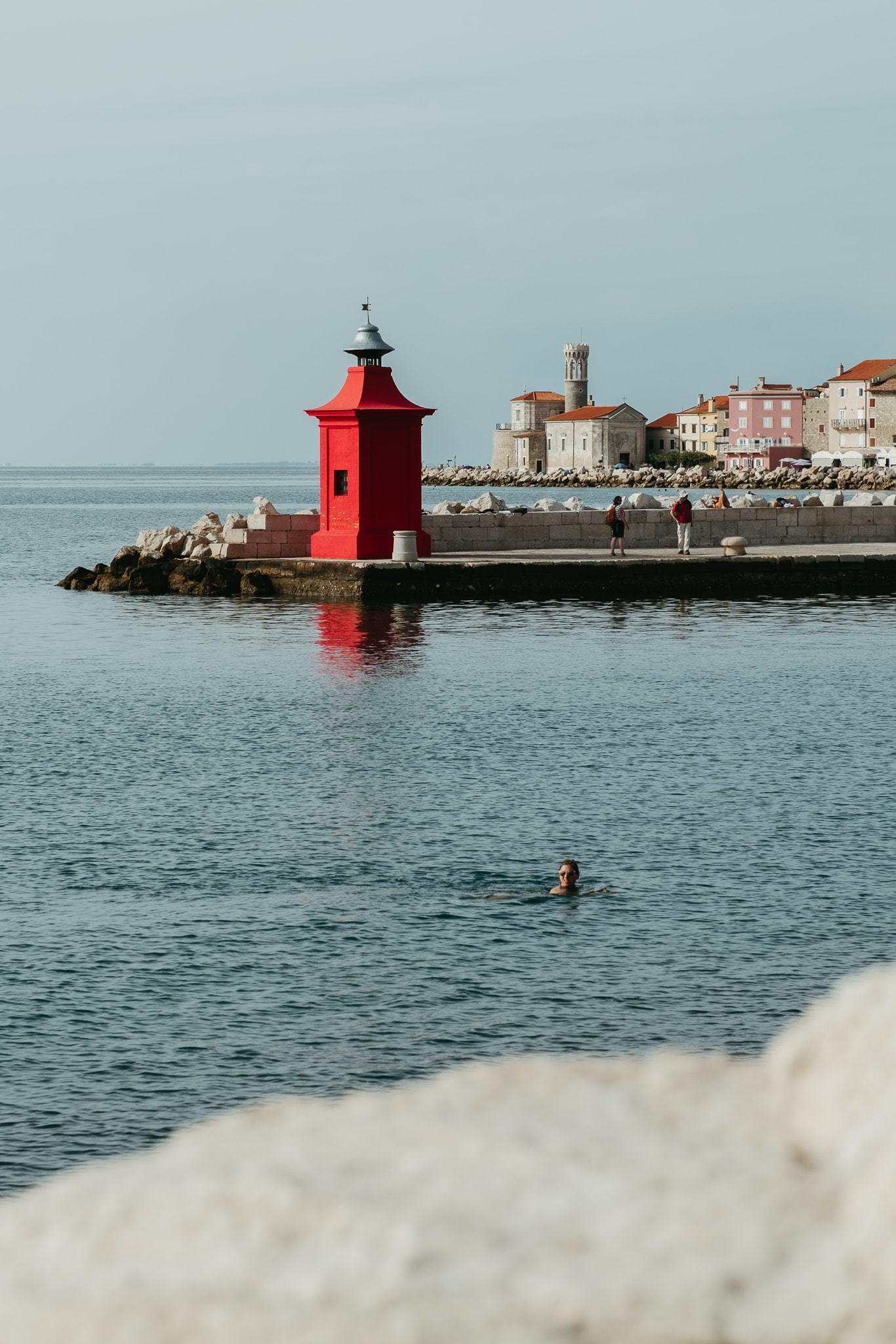 A bright red lighthouse in Piran, Slovenia.