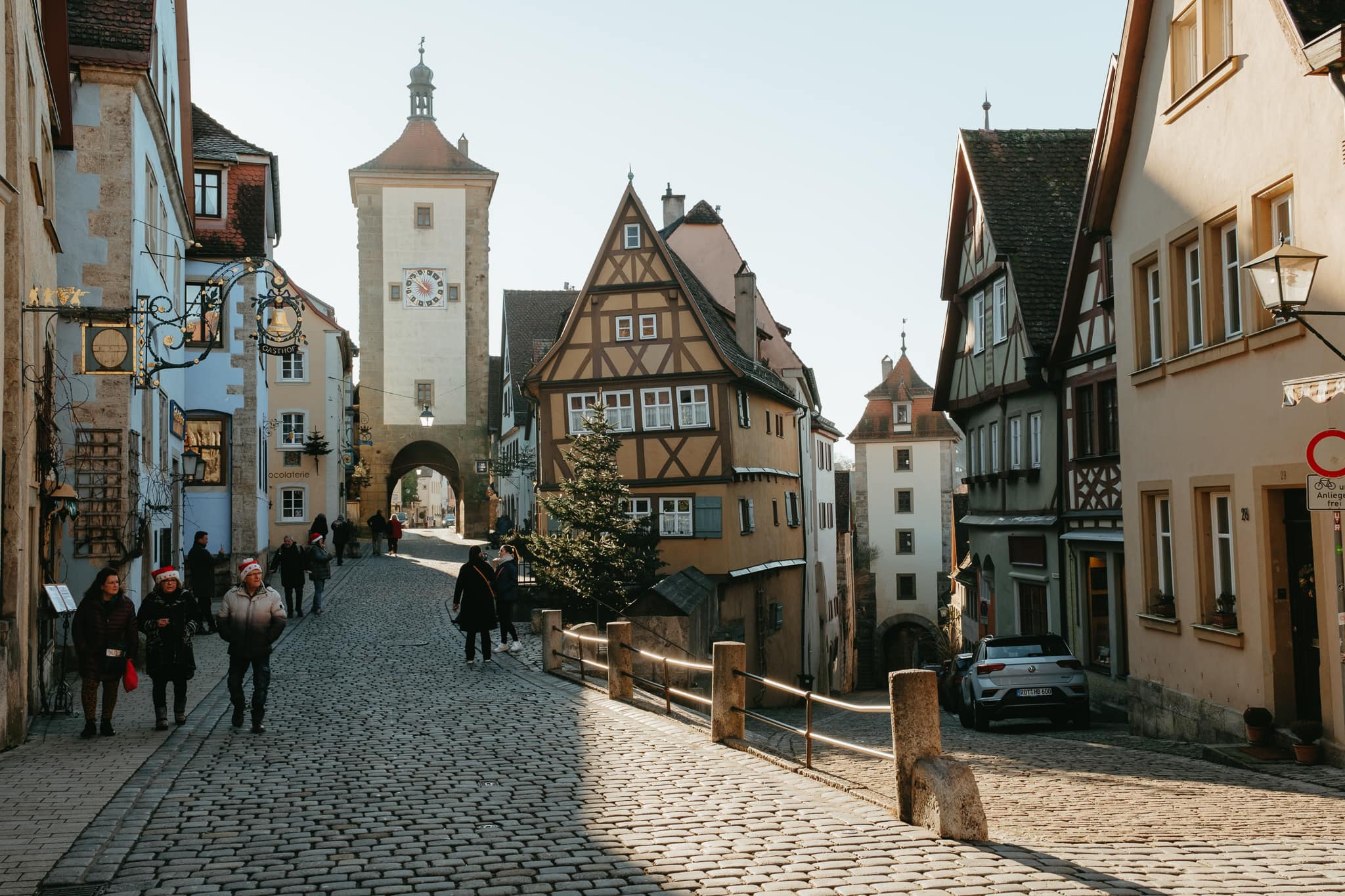 People walk down the street at Rothenburg ob der Tauber's famous Plonlein viewpoint.