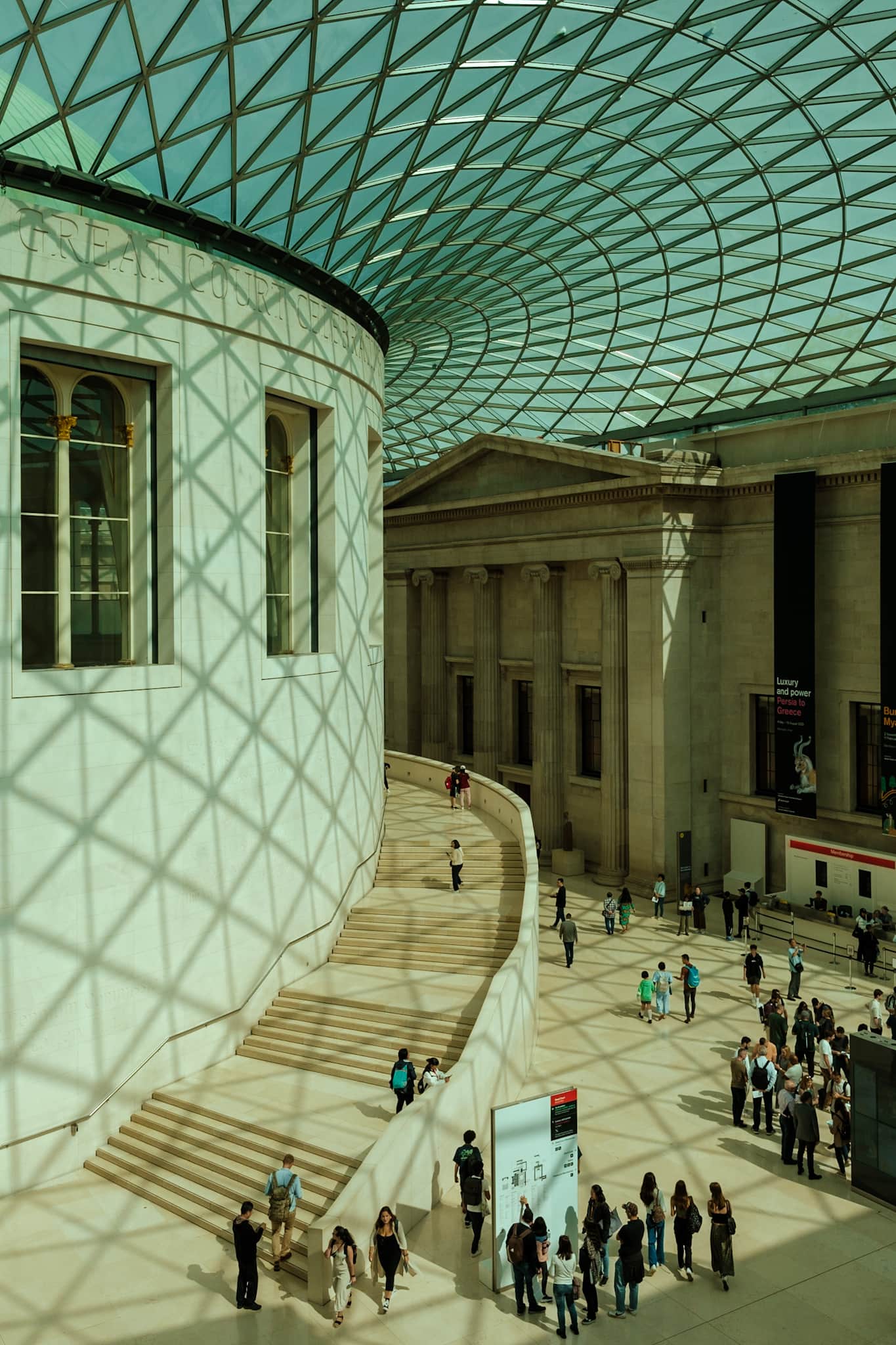 An interior courtyard in the British Museum, with a blue glass paneled ceiling.