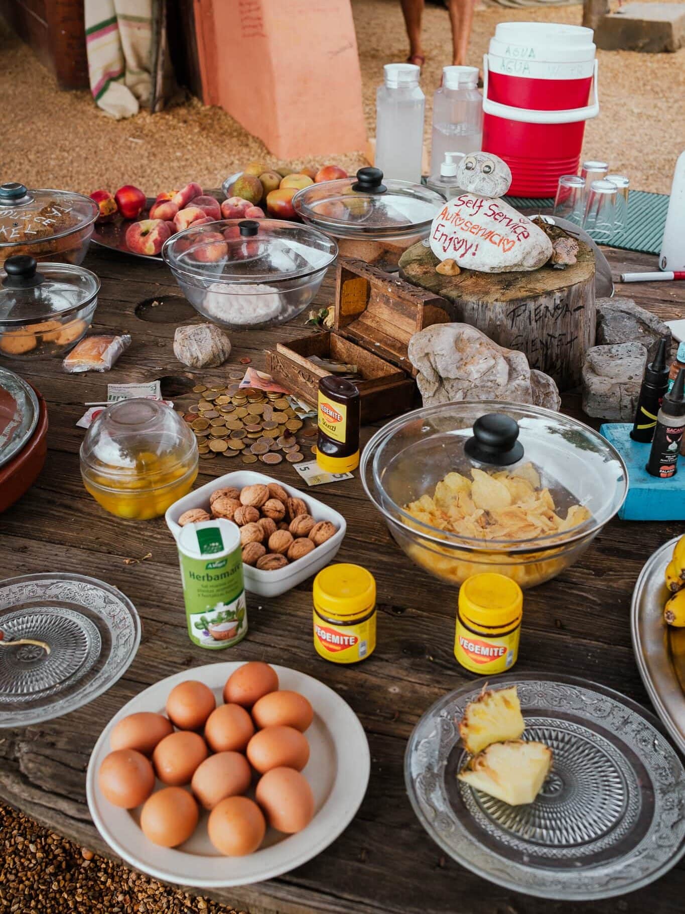 A table full of plates and bowls of various kinds of food.