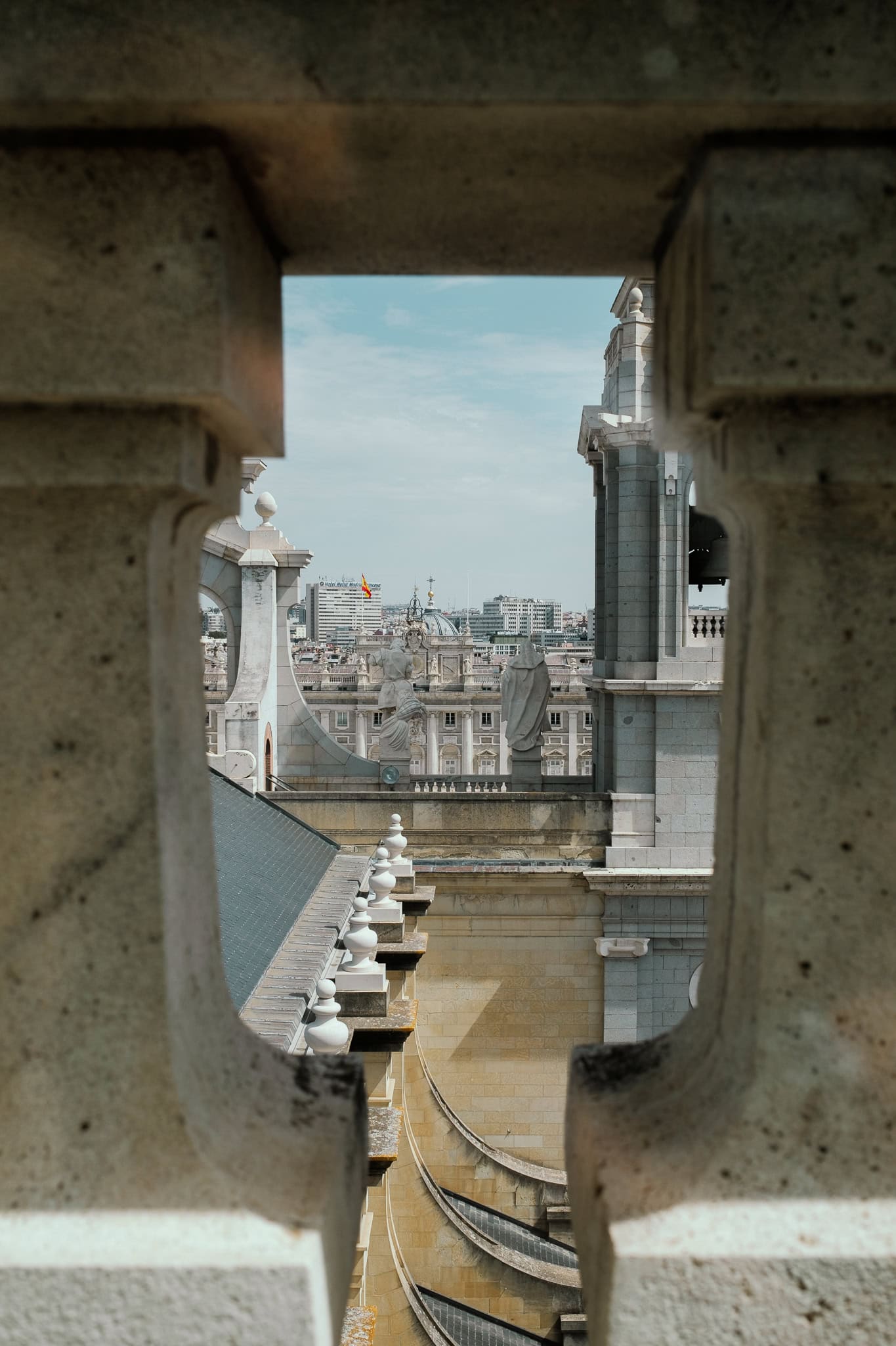A glimpse of the Royal Palace, viewed through a balustrade on Almudena Cathedral.