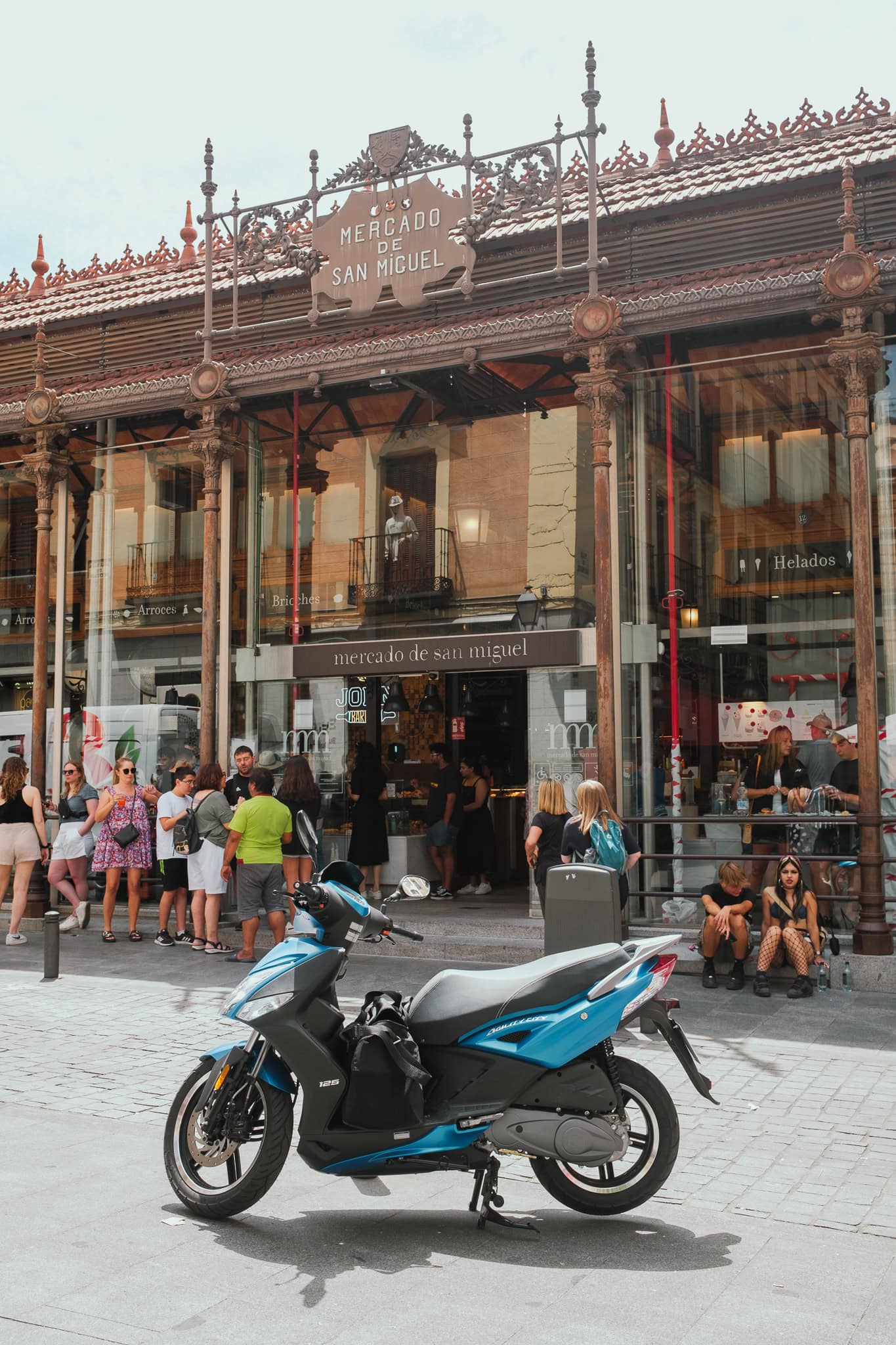 A motorcycle sits outside Mercado de San Miguel.