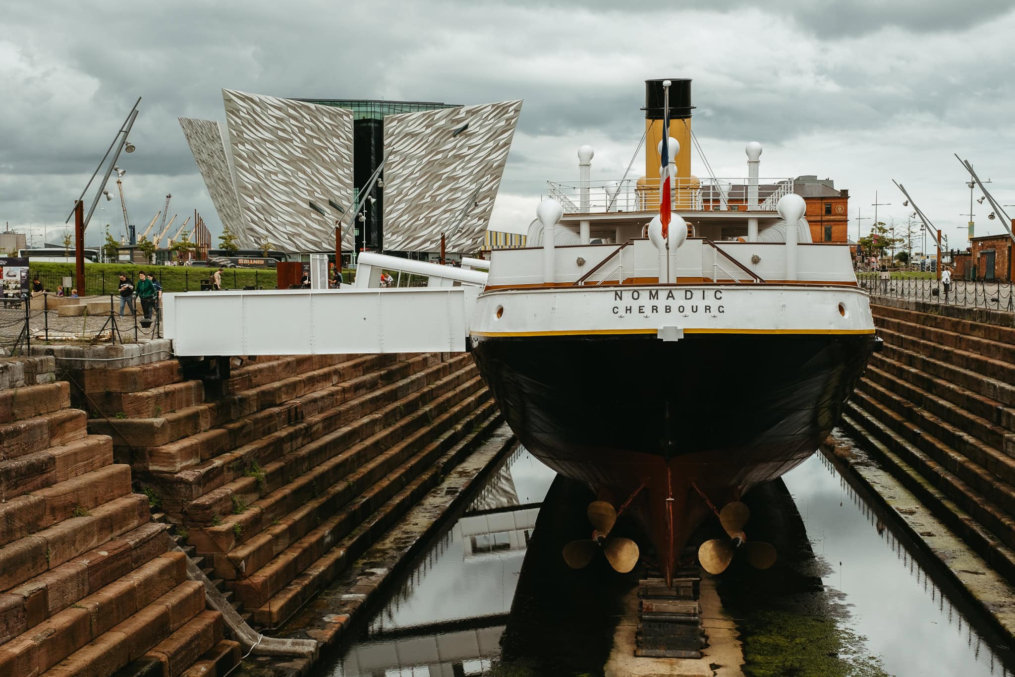 The SS Nomadic tender ship in front of the Titanic Belfast museum.