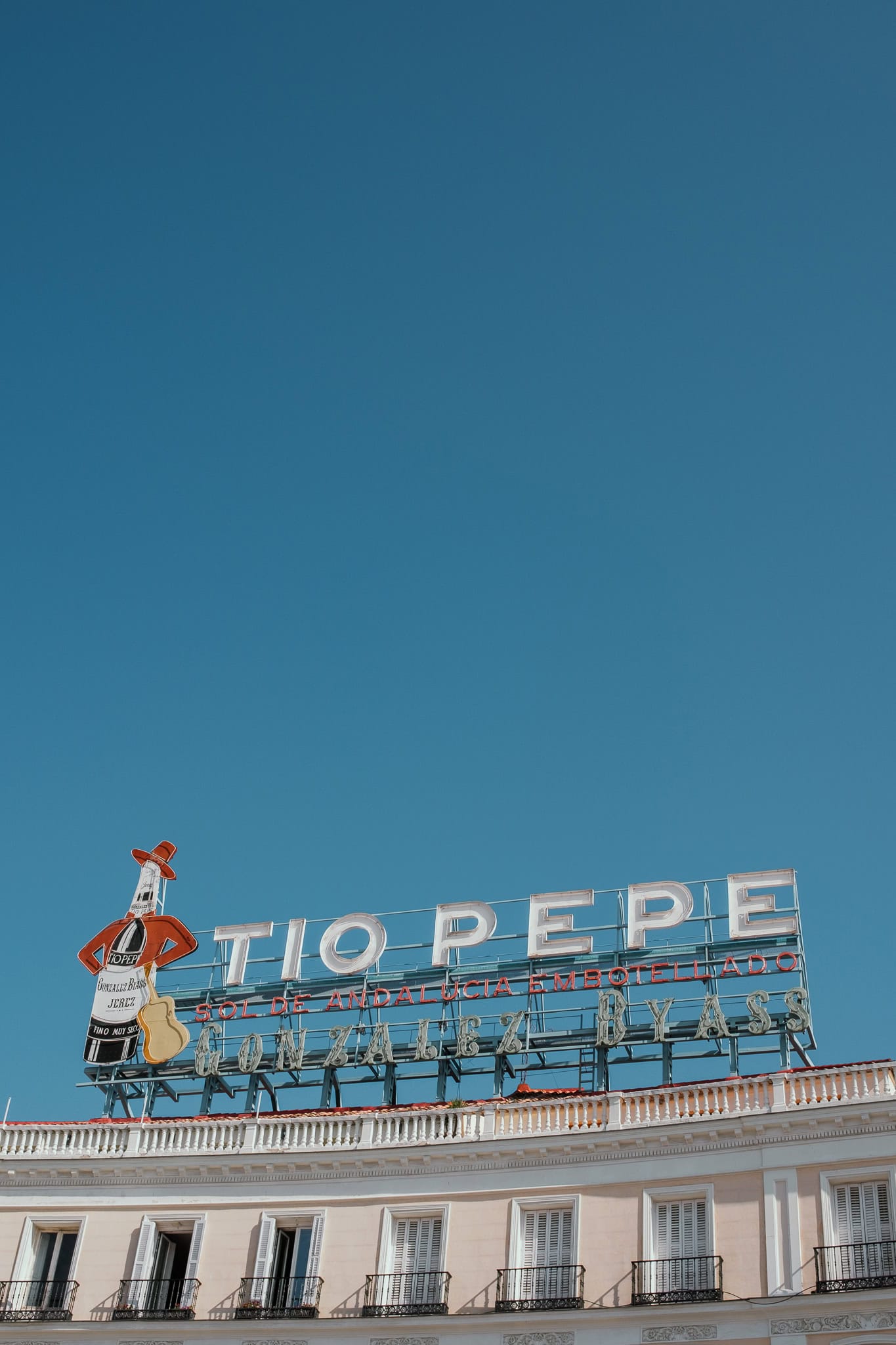 Neon Tio Pepe advertisement on a rooftop in Puerta del Sol.