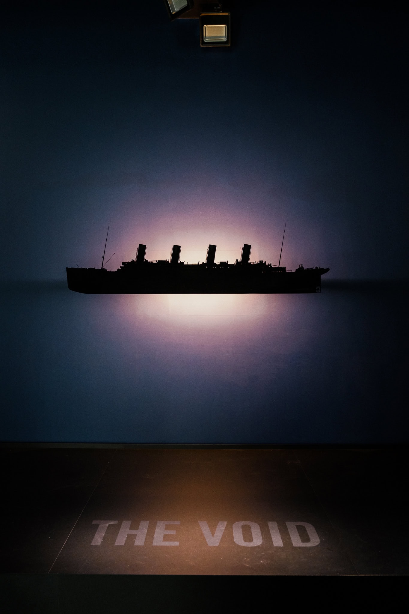 A backlist model of the Titanic above the words "the void."