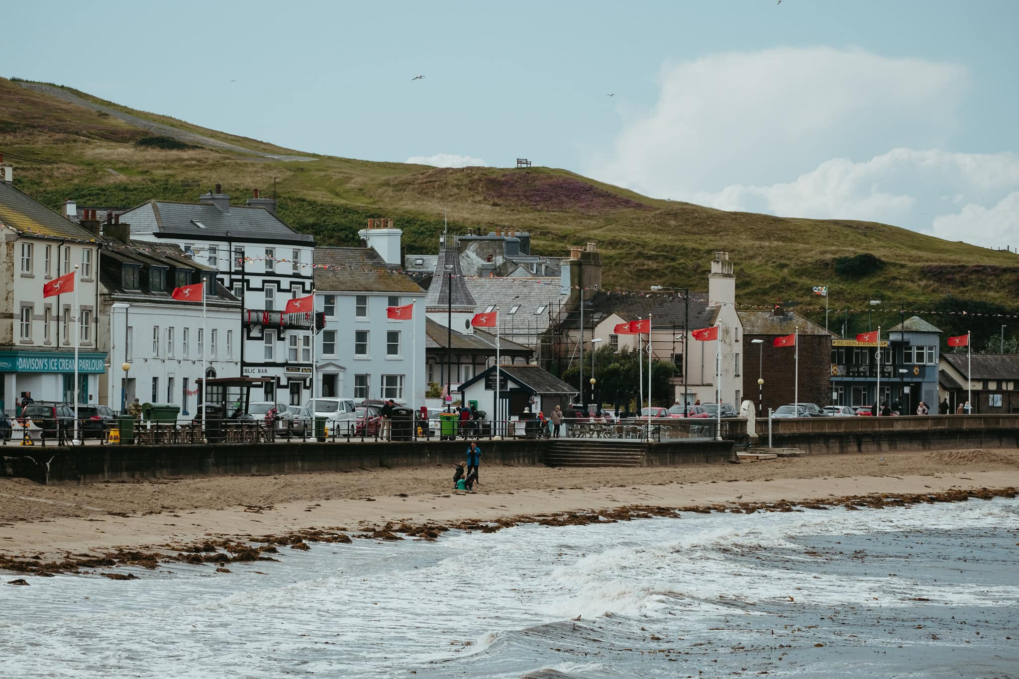 Isle of Man flags flying along the Peel promenade.