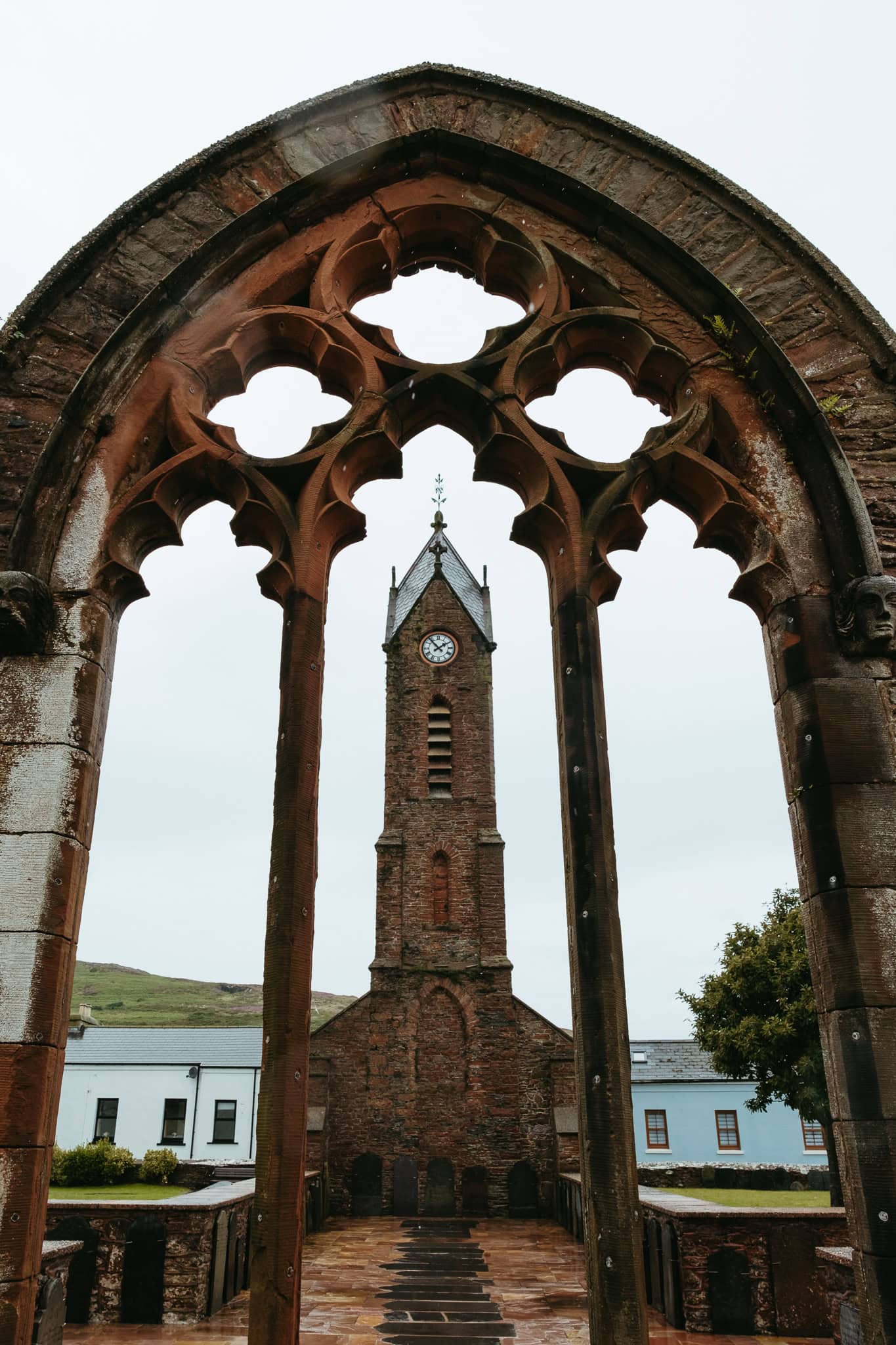 A church tower through an empty window.
