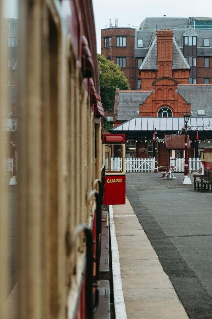 A train, with an open door that says "Guard," sitting at Douglas's railway station.