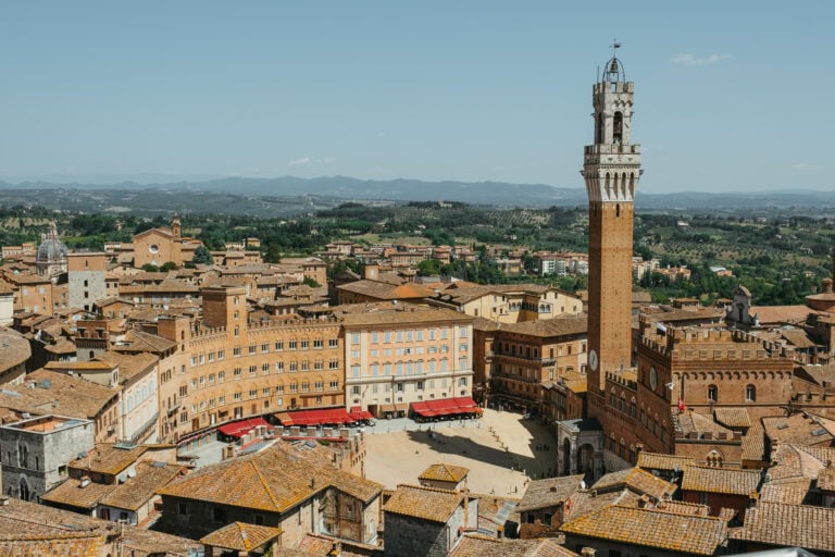 View of Piazza del Campo, Torre del Mangia, and the surrounding countryside from Facciatone.