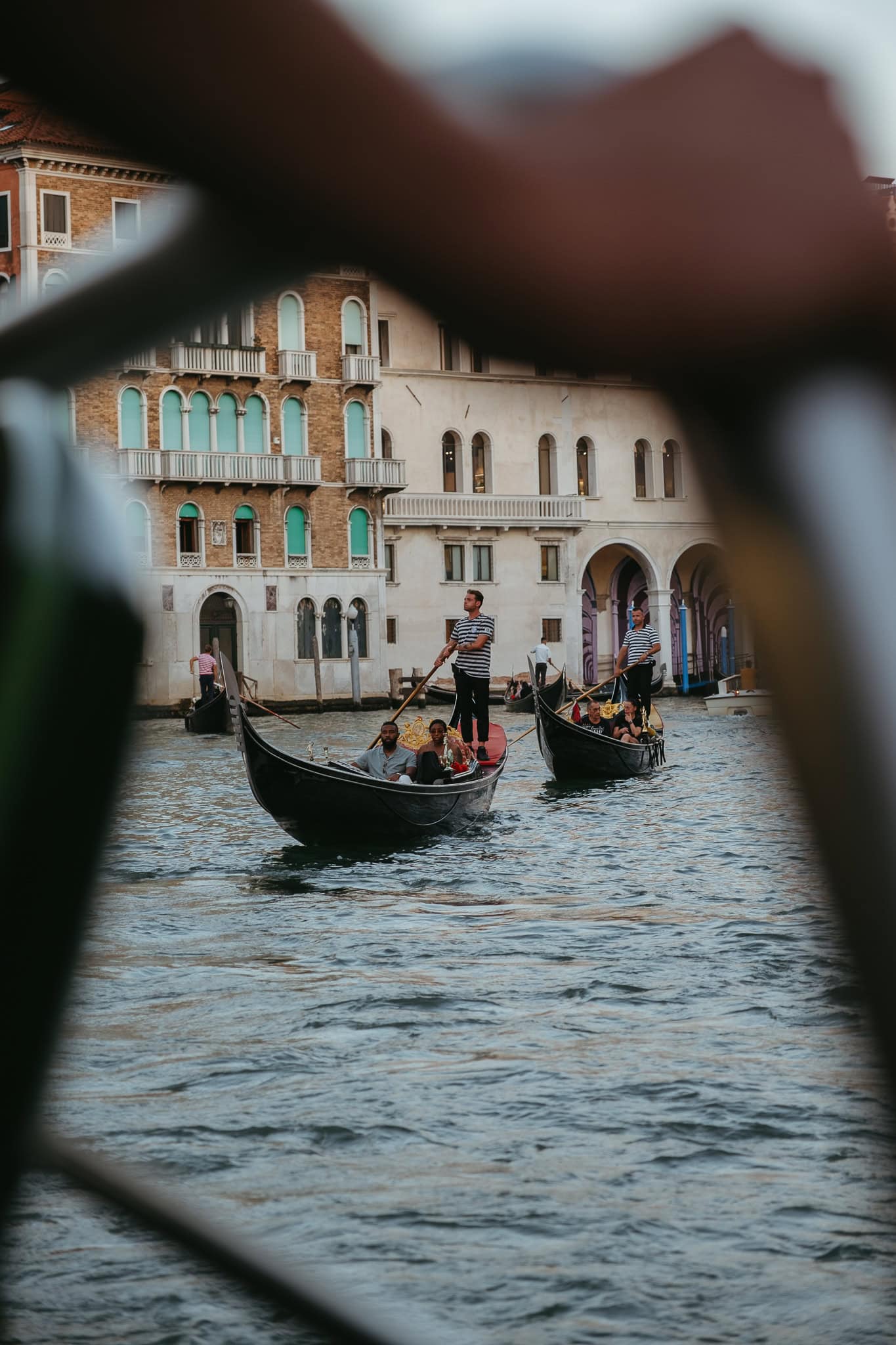 Two gondolas float on the Grand Canal at sunset.