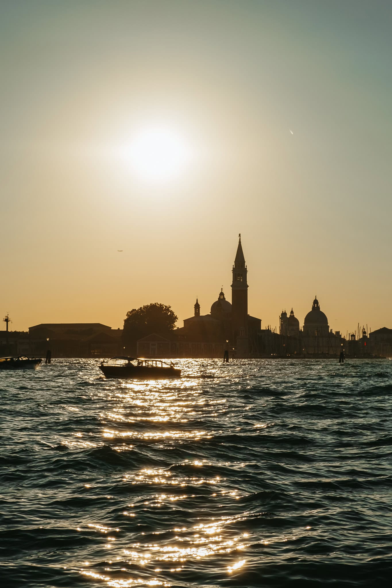 The silhouette of San Giorgio Maggiore with a setting sun above it.