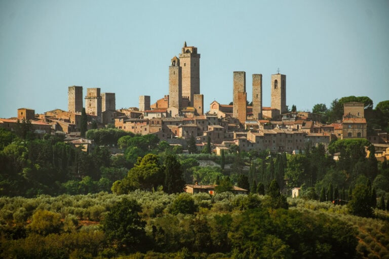The towers of San Gimignano in front of a blue sky.