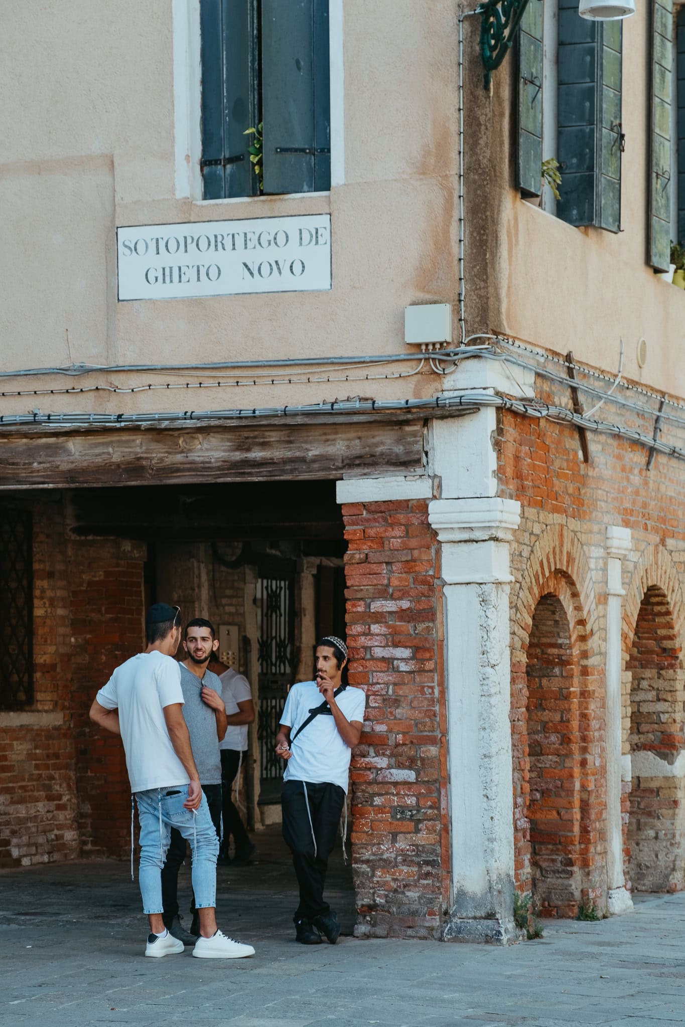 Young men standing at a corner.