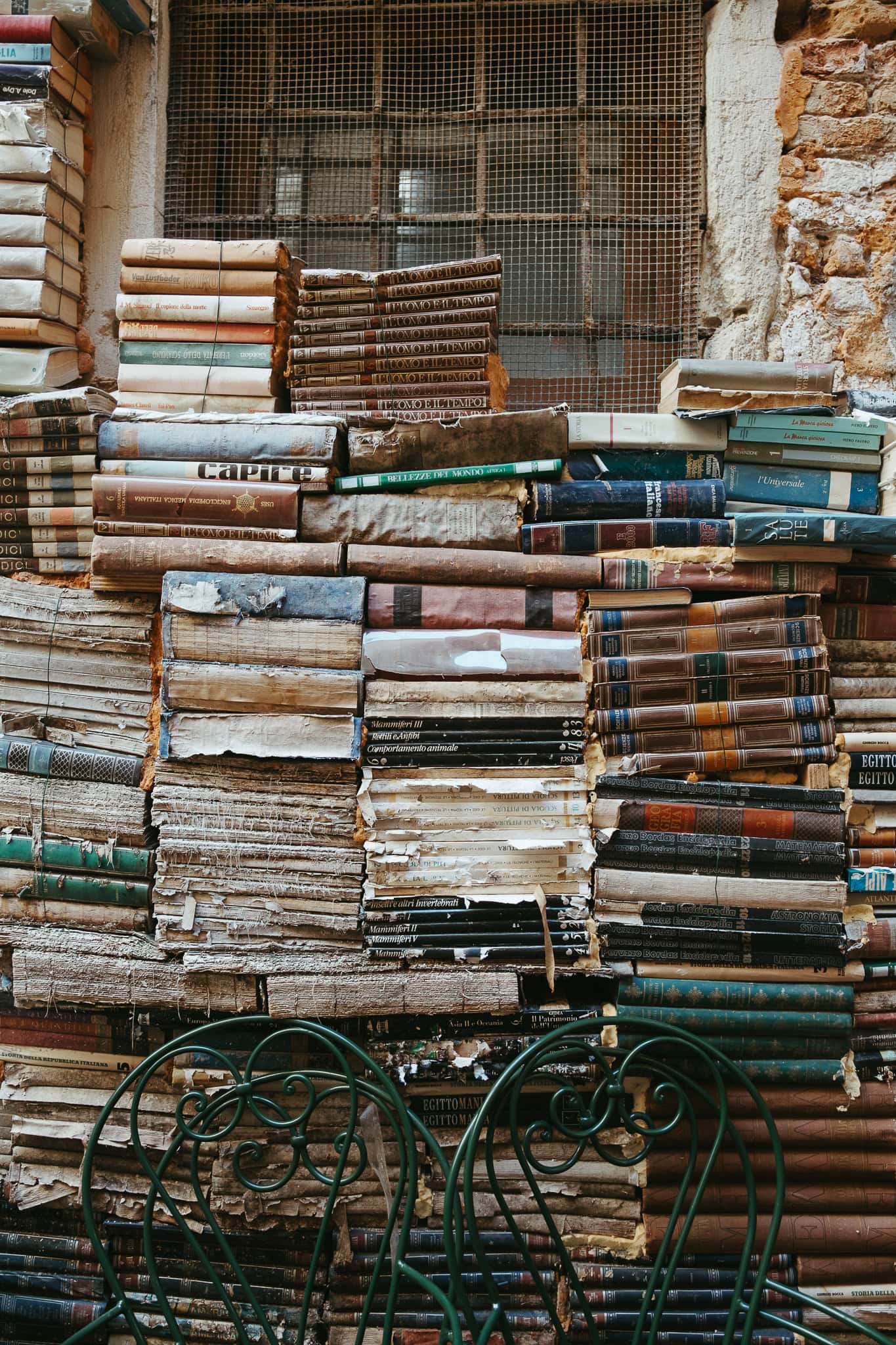 Stacks of books in a courtyard.