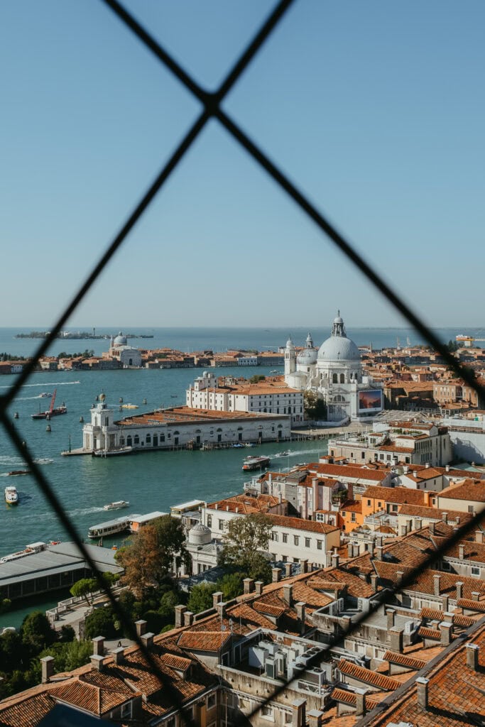 Basilica of Santa Maria della Salute, as seen through a fence in a tower high above.