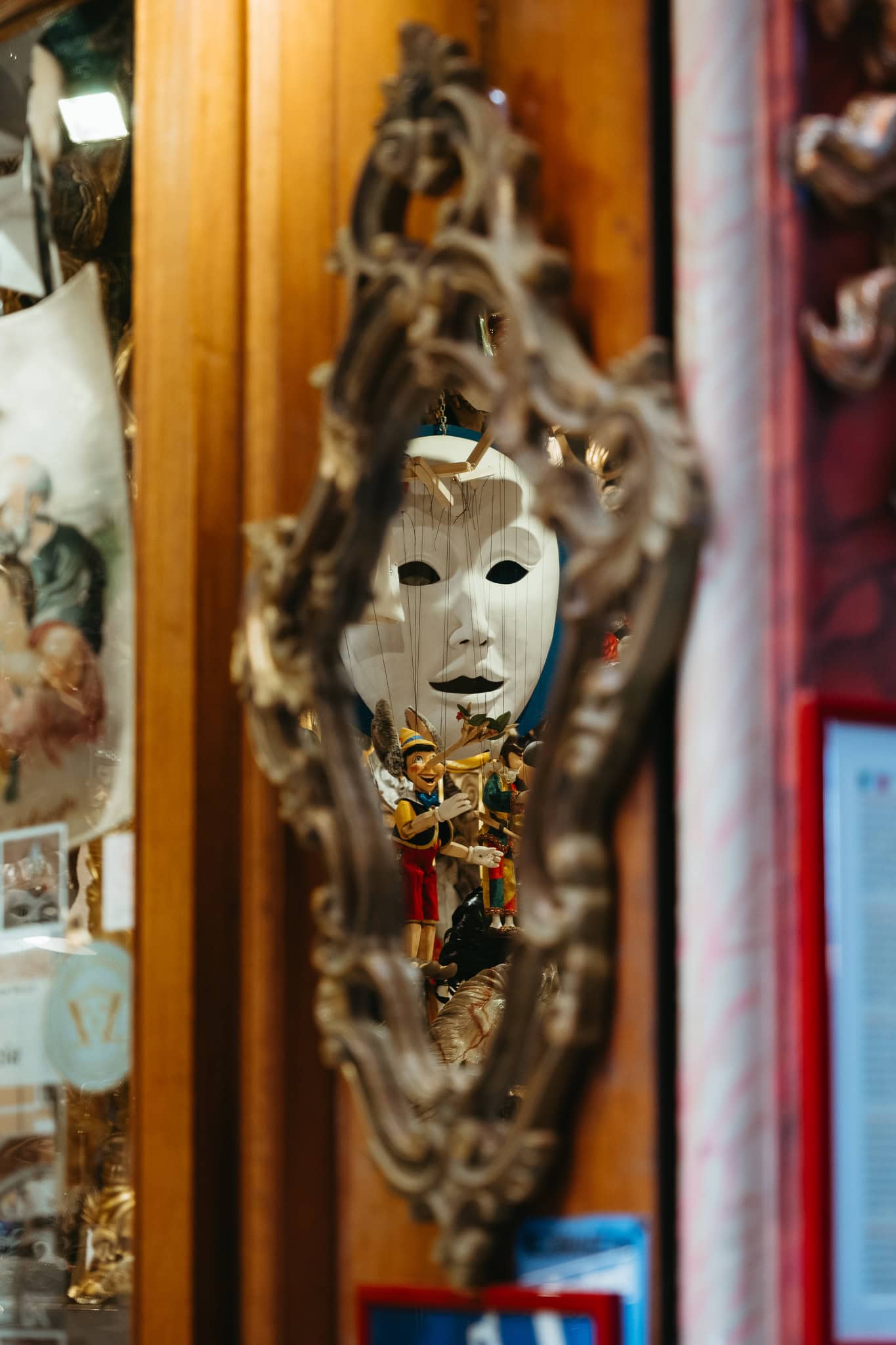 A white mask reflecting in a mirror.