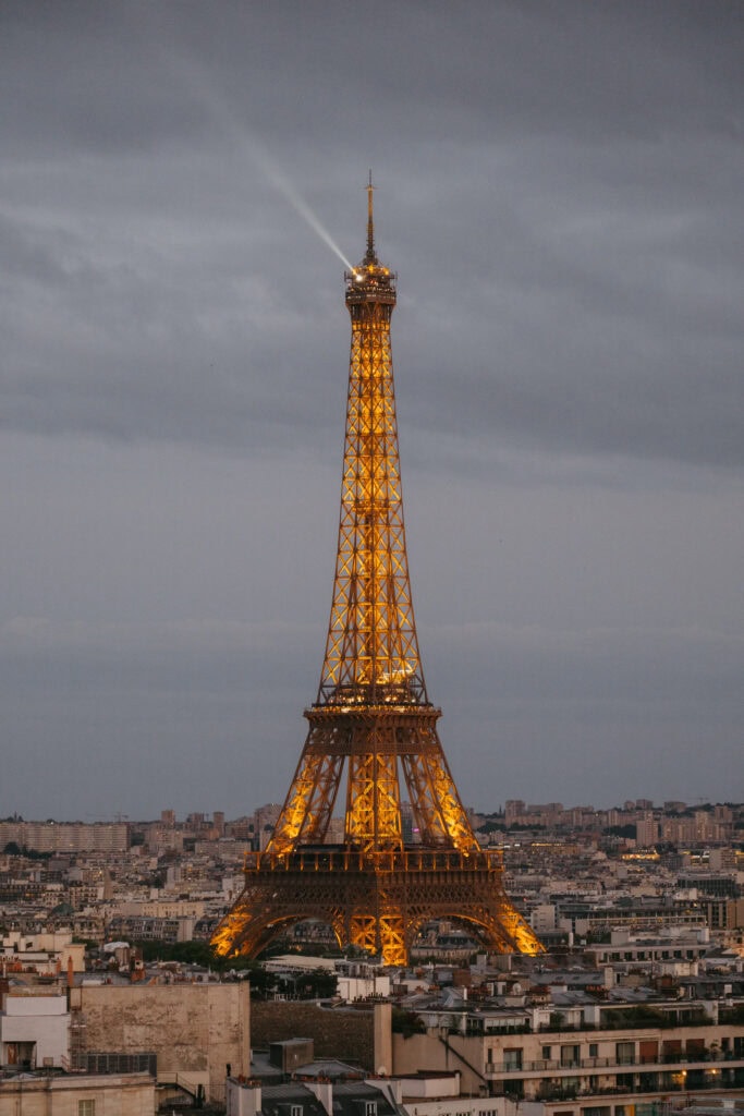 The Eiffel Tower lit up in the early evening.