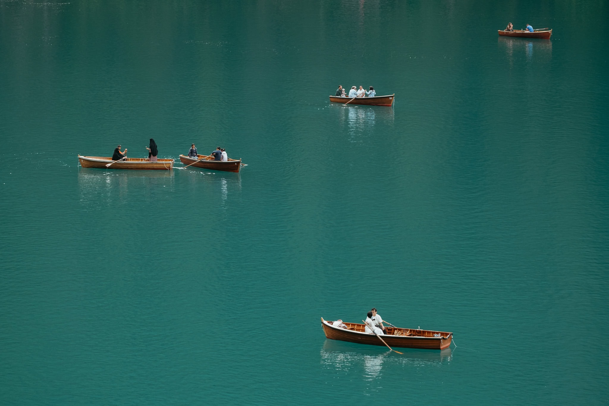 People boating on Lago di Braies.