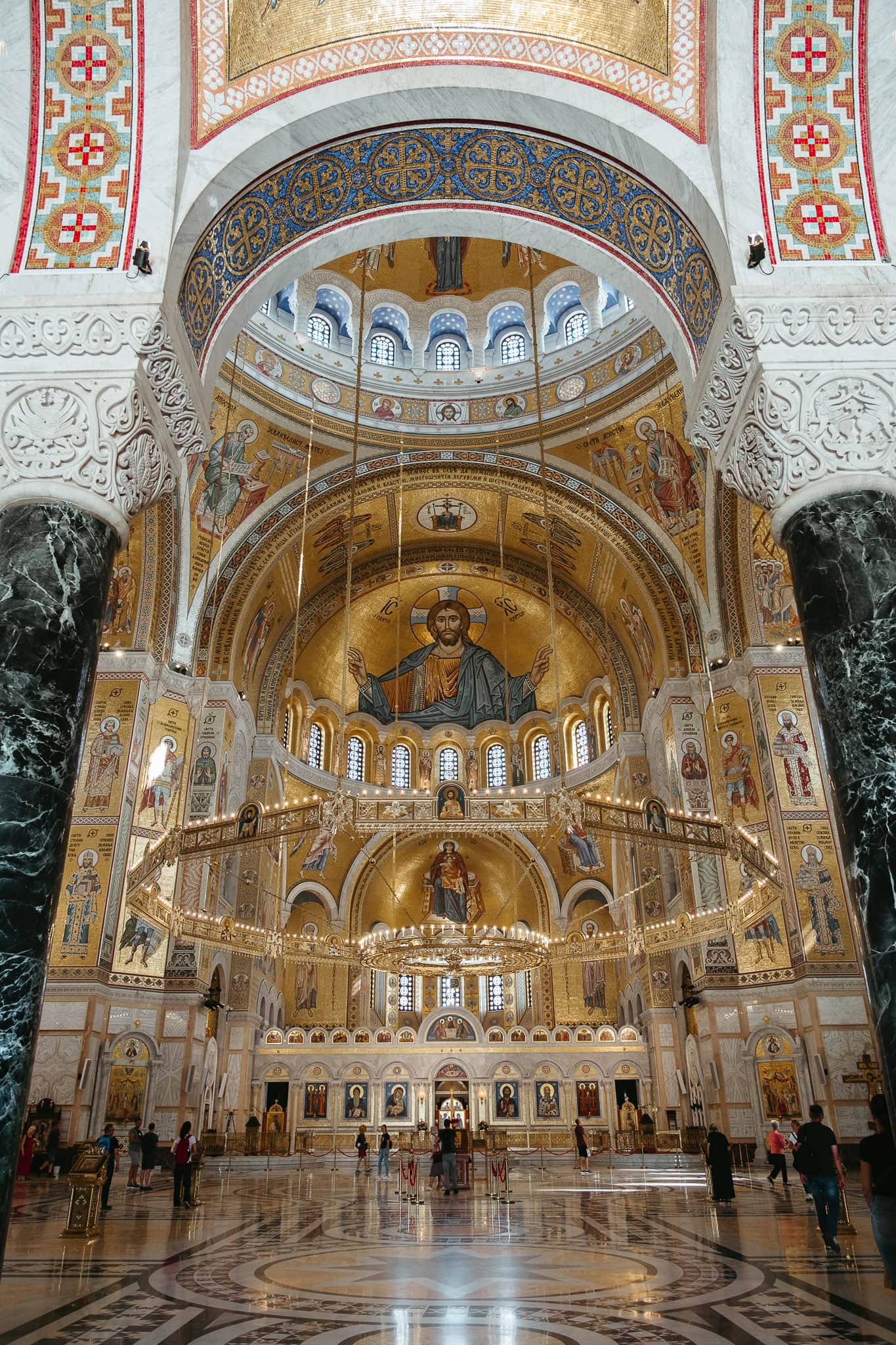 The ornate interior of Saint Sava, with golden mosaics.