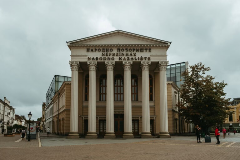 A building with large pillars and Cyrillic writing.