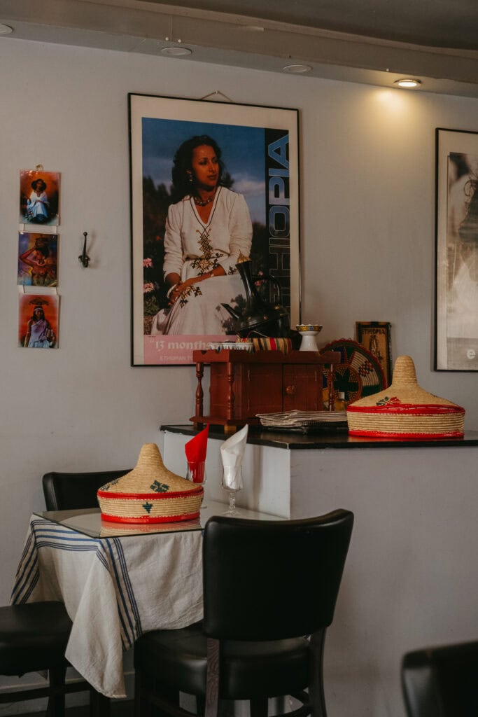 A table and art inside a restaurant.