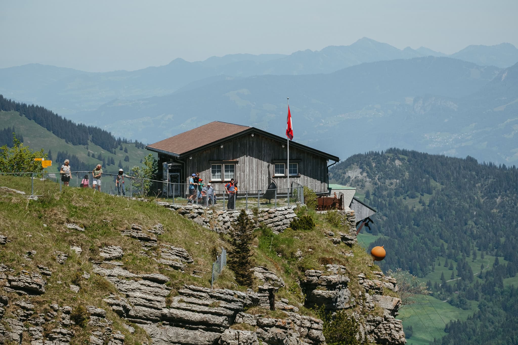 A small building sits on top of a mountain.