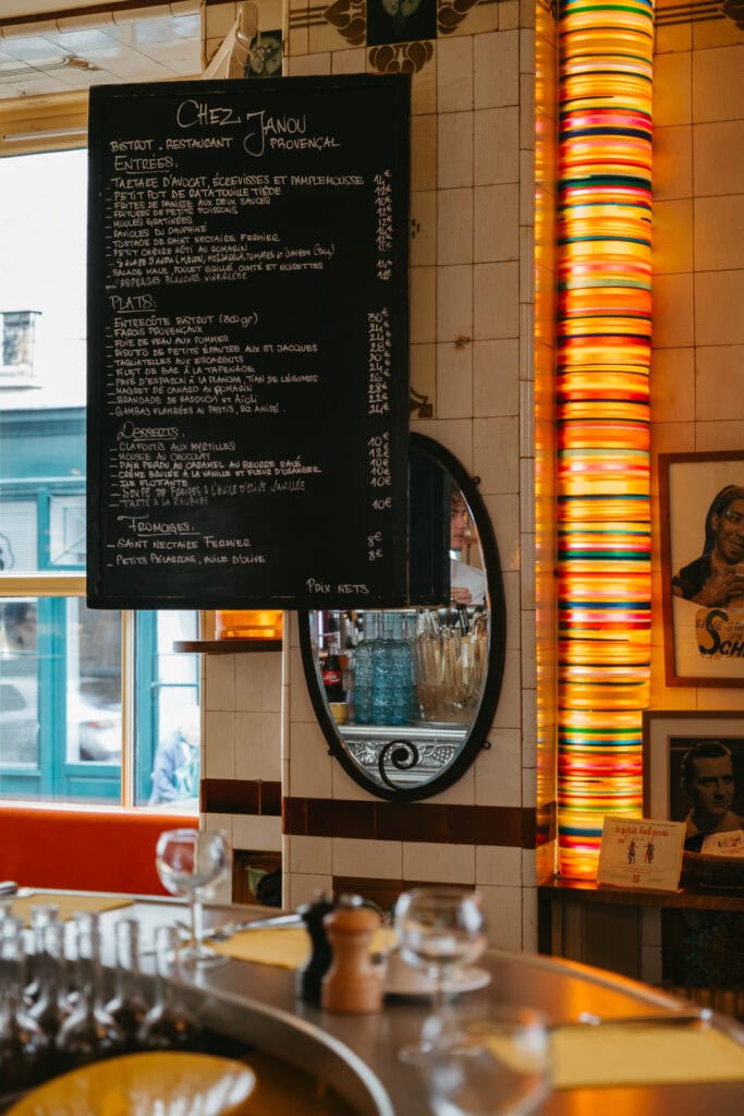 A handwritten menu board inside a restaurant.