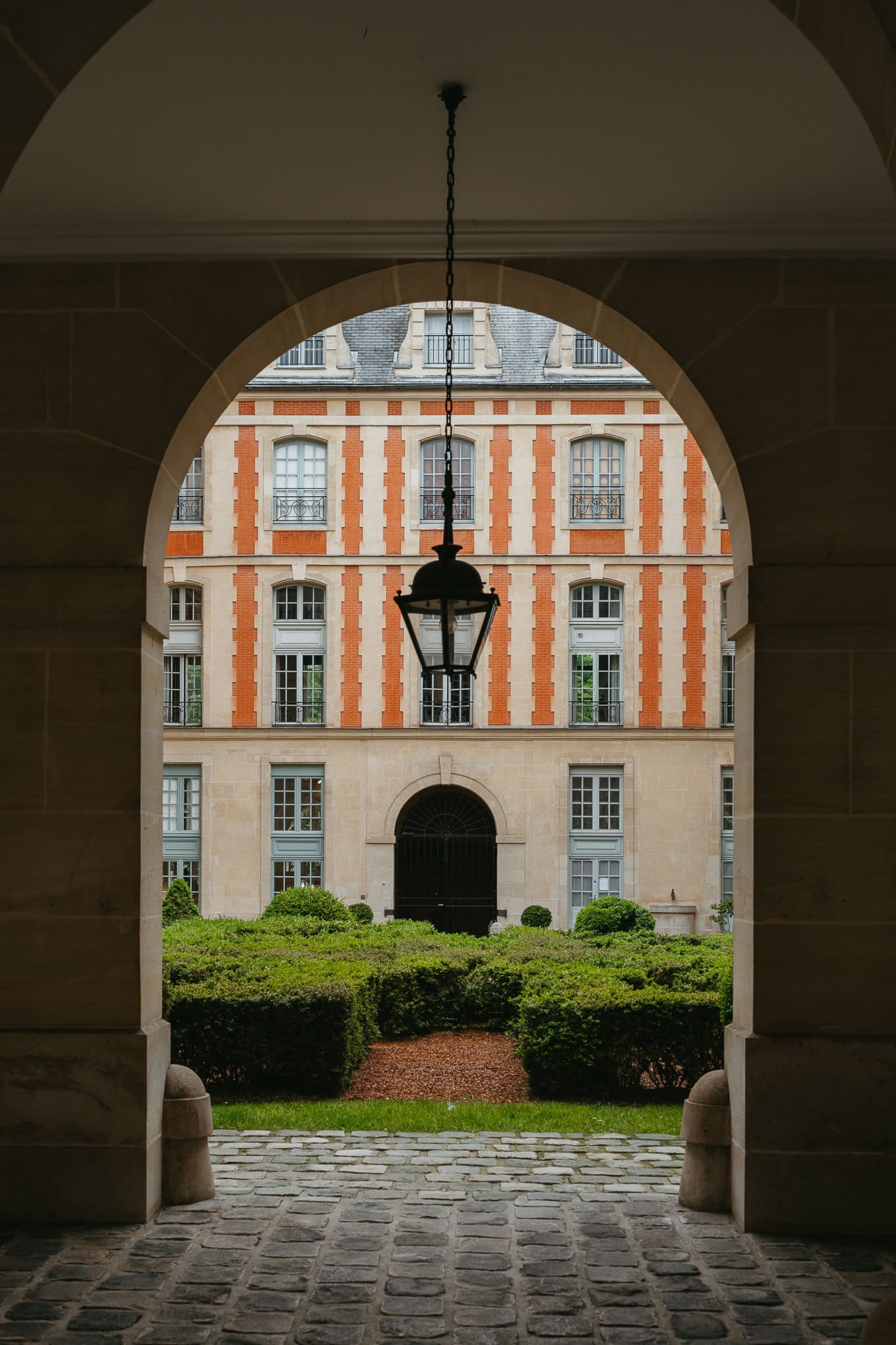 Looking into a Parisian courtyard through an arch.