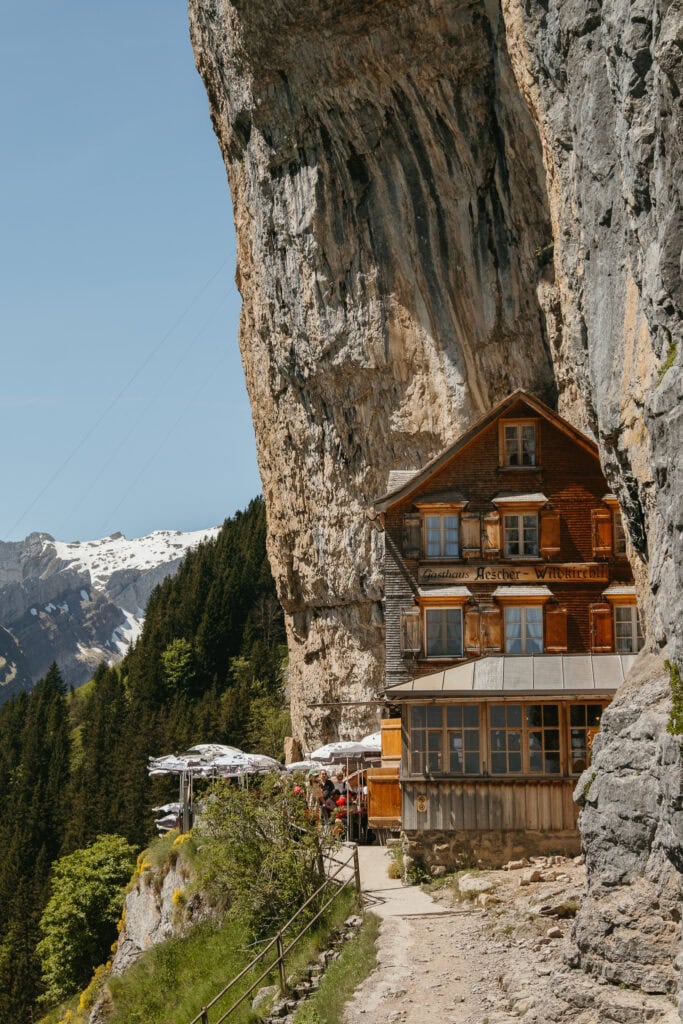 A wooden guesthouse sitting on the side of a cliff.