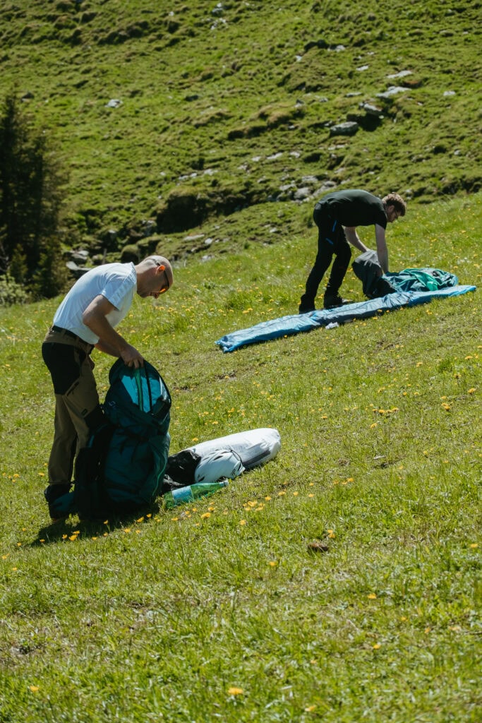 Paragliders unfurl their equipment.