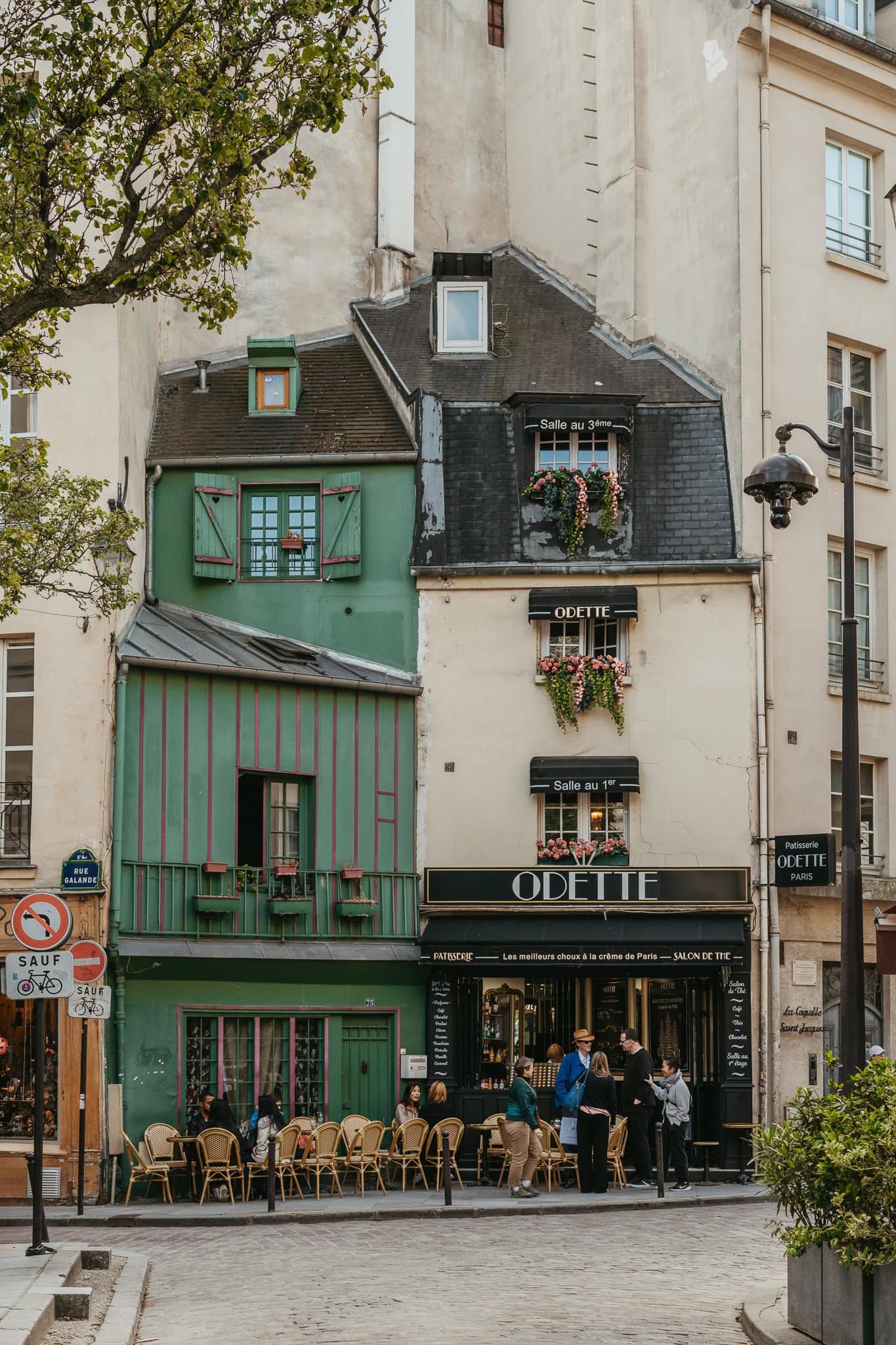 A green and cream patisserie at the end of the street, labeled "Odette."