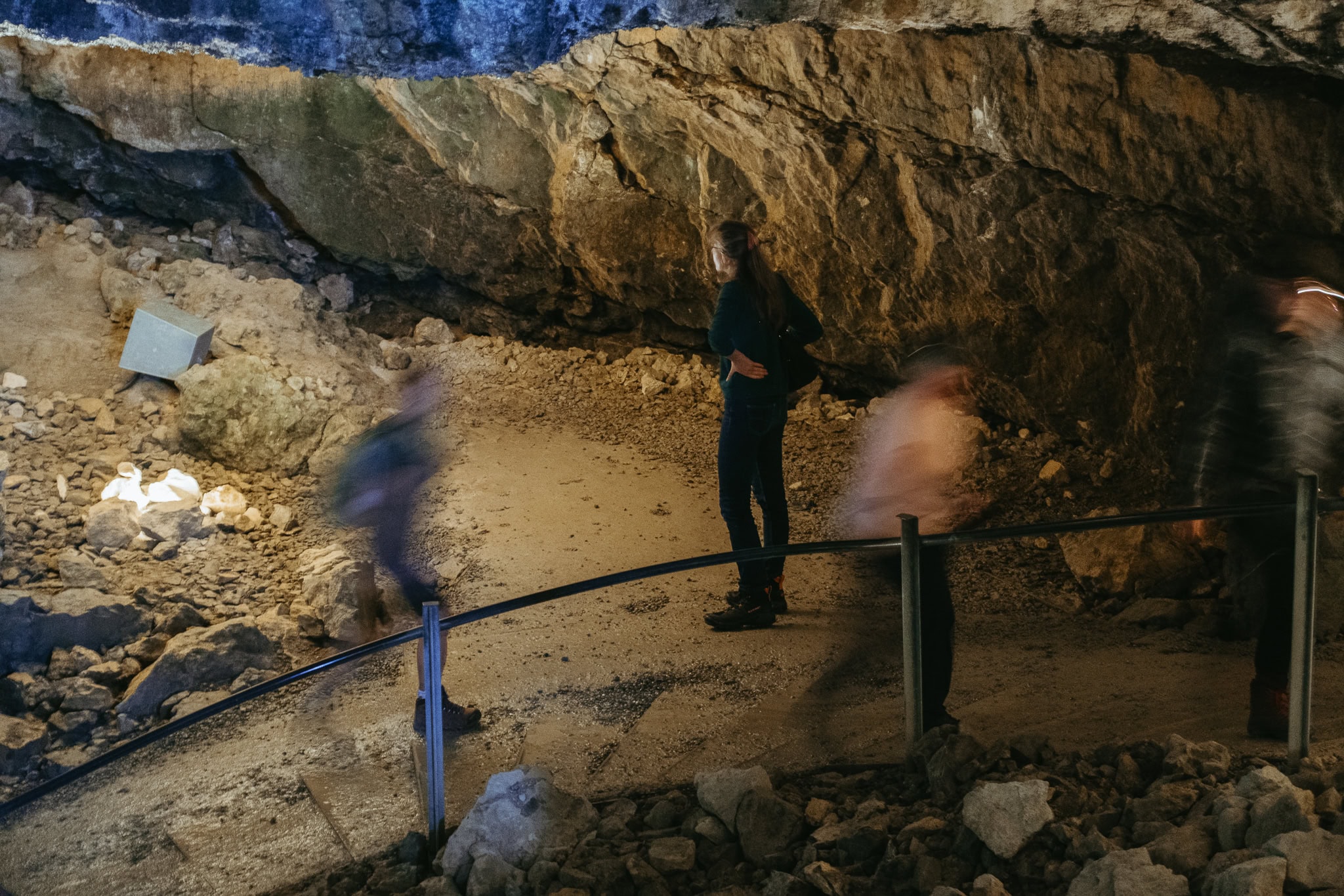 People walk through a cave.