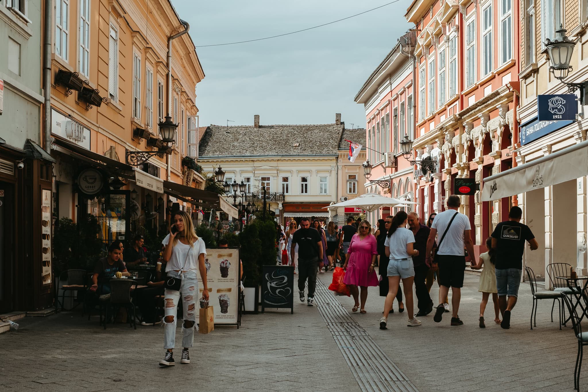People walking down a pedestrian street.