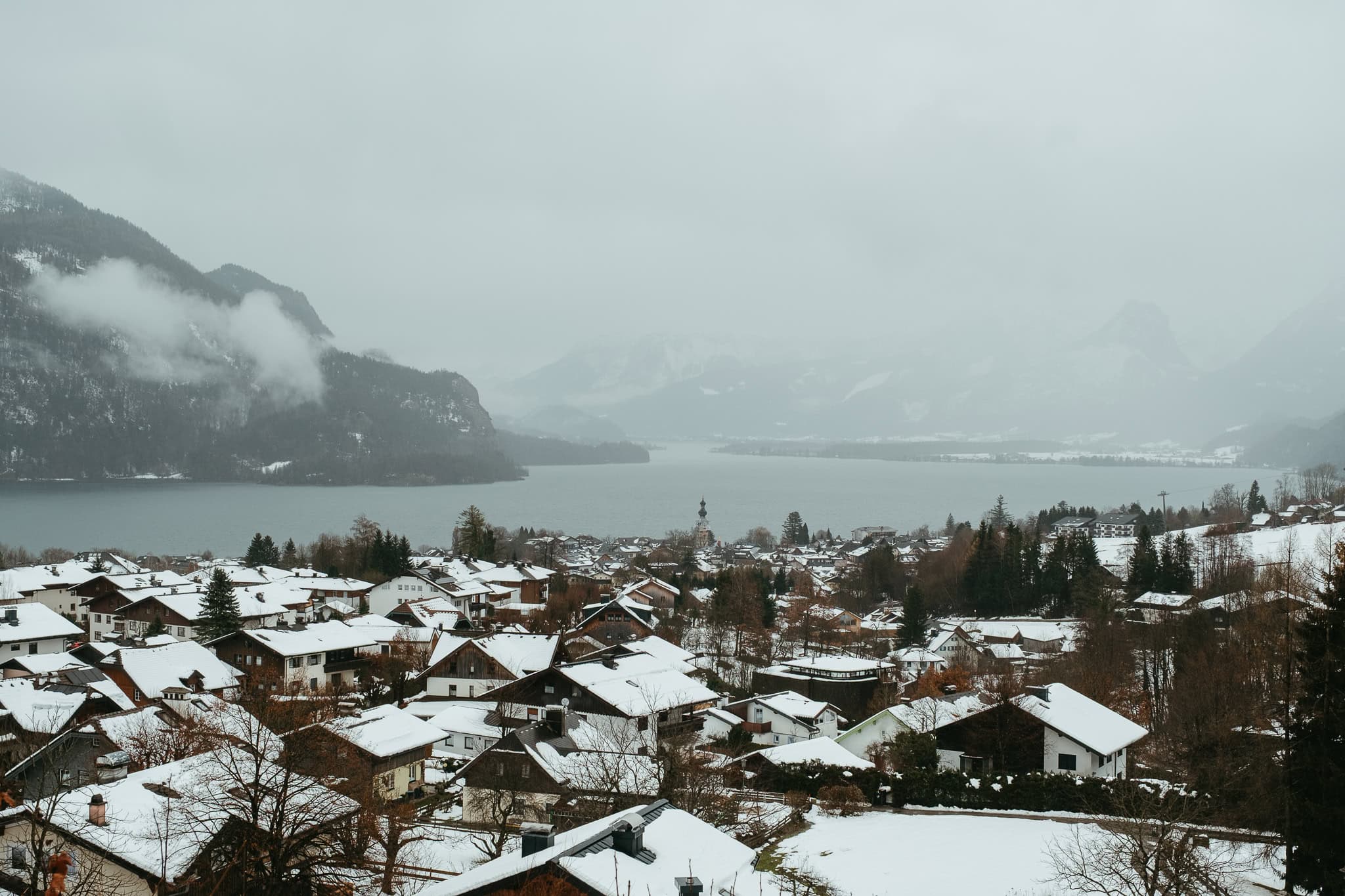 A small town beside a foggy lake.