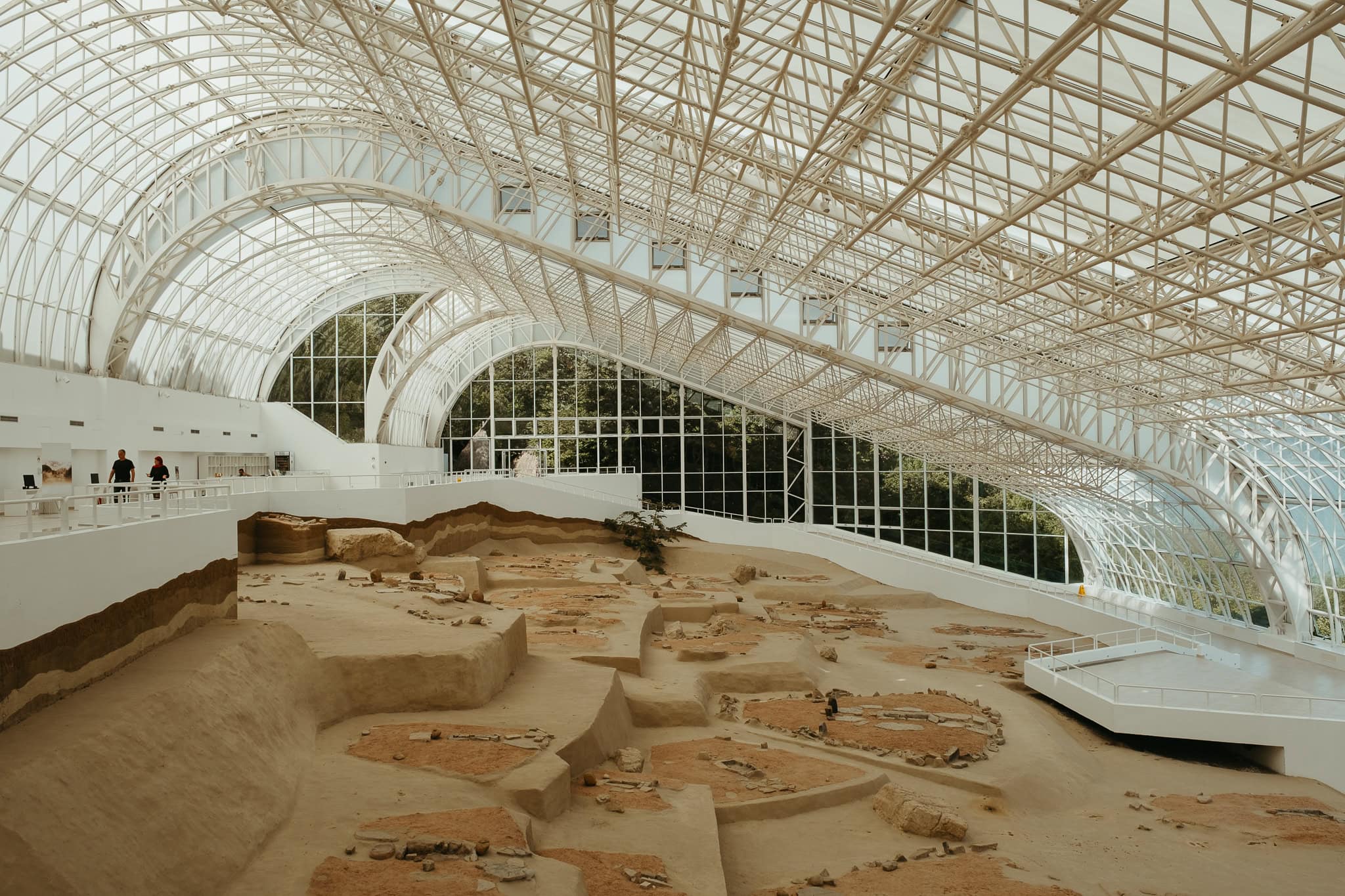 Excavation site at Lepenski Vir, with dwelling layout under a large glass ceiling.