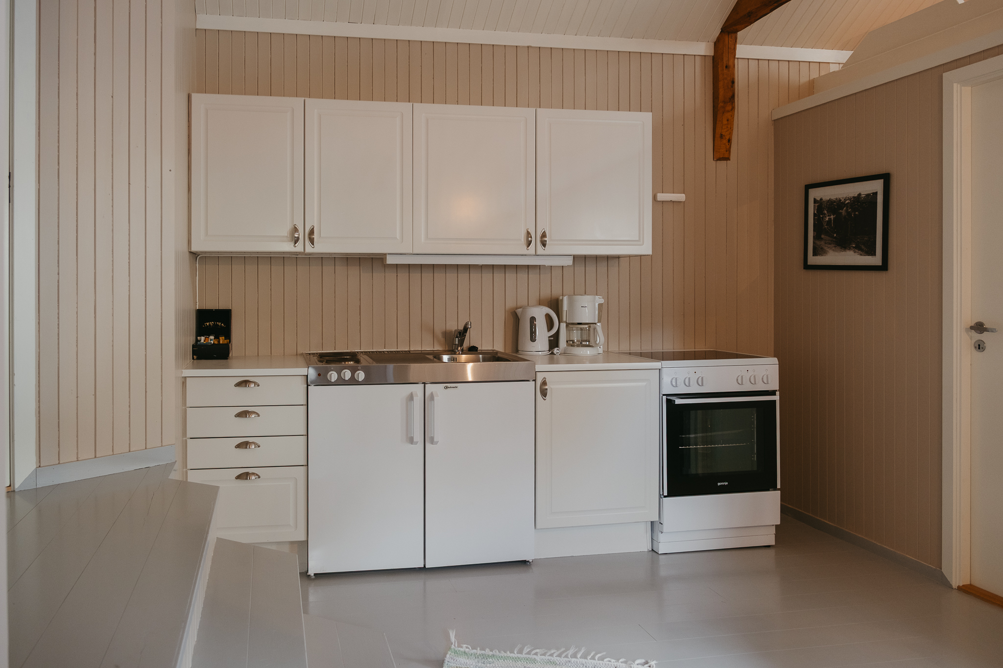 A wall with a kitchenette inside a cabin.