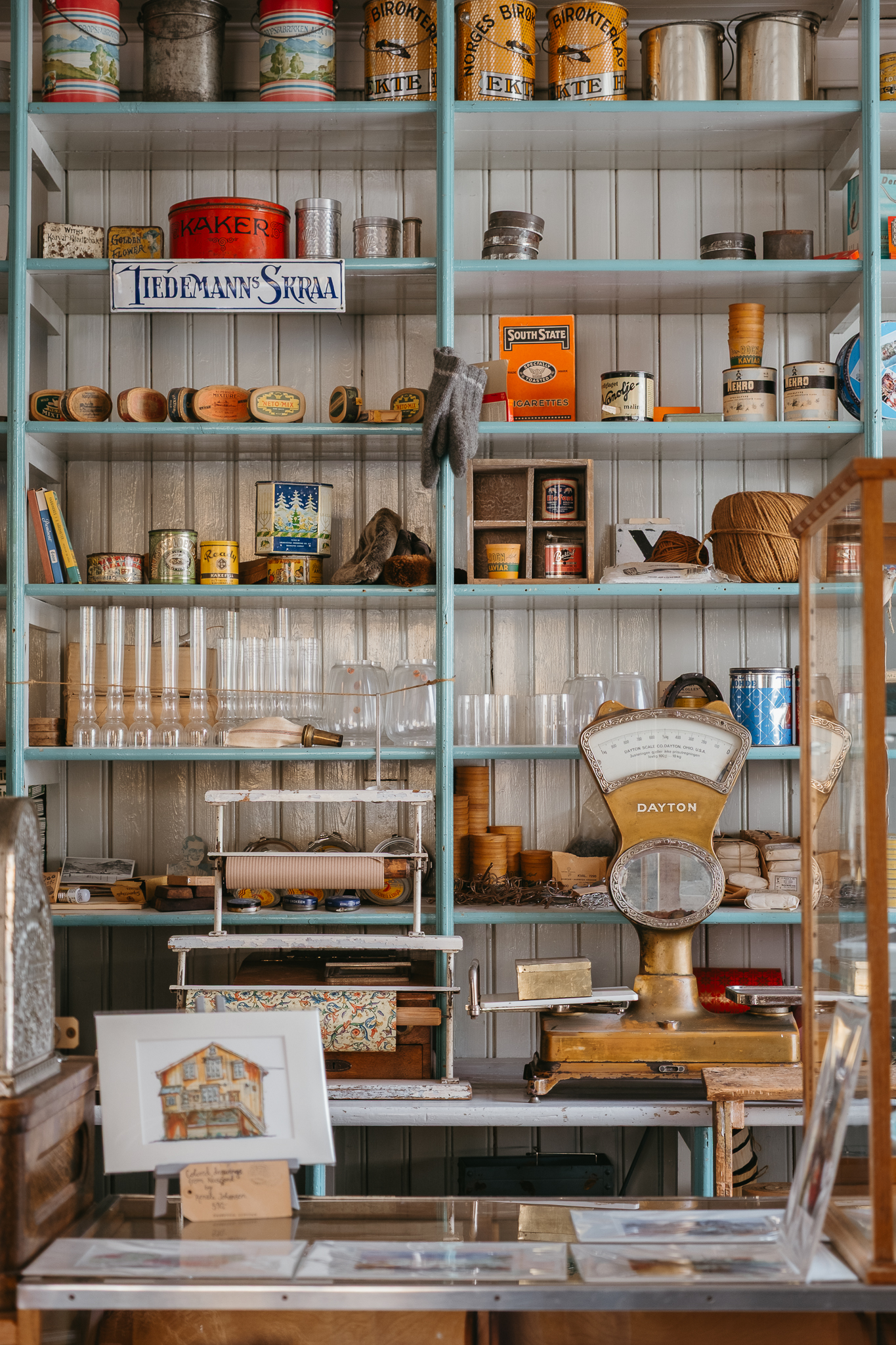Shelves displaying old objects inside a cafe.