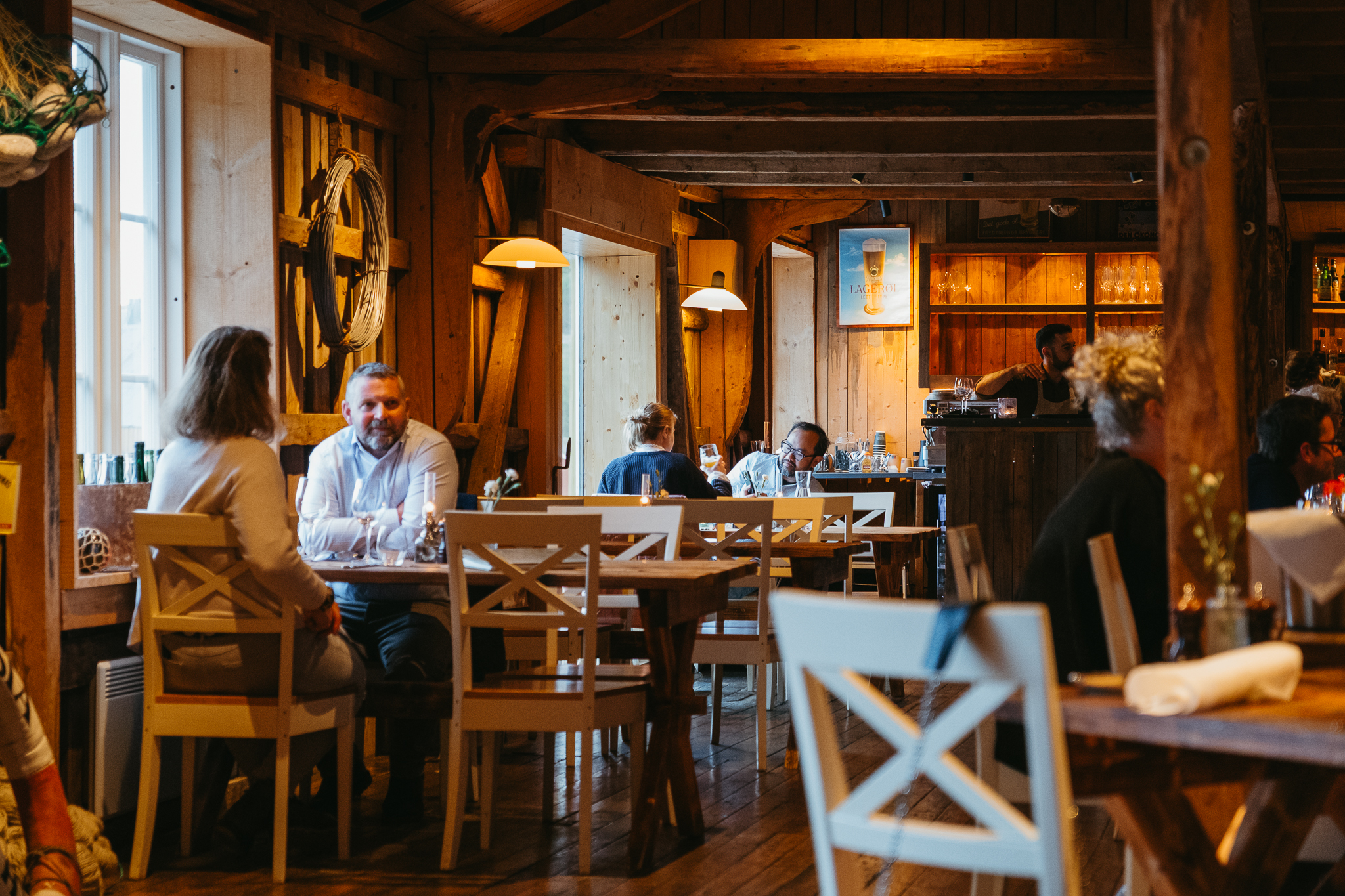 People sit inside a rustic restaurant.